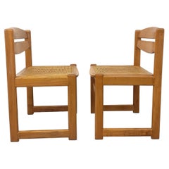 Paire de chaises traîneau vintage en bois de hêtre et cannage des années 70 80