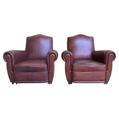 Paire de fauteuils club en cuir 1950