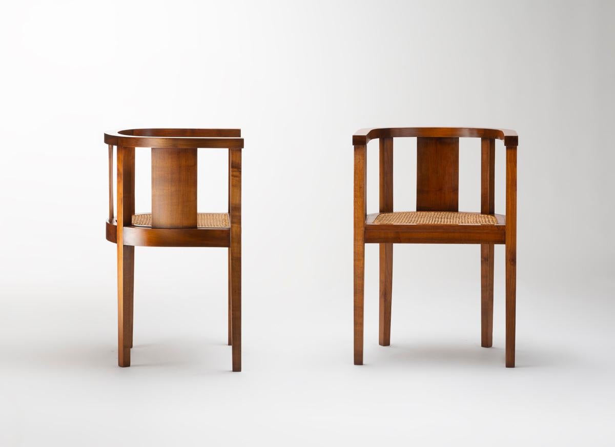 Queste sedie, disegnate da Francis Jourdain nel 1922, riflettono un approccio raffinato ai primi mobili modernisti. Realizzato in legno con una calda finitura naturale, presenta un caratteristico schienale semicircolare sostenuto da doghe verticali.