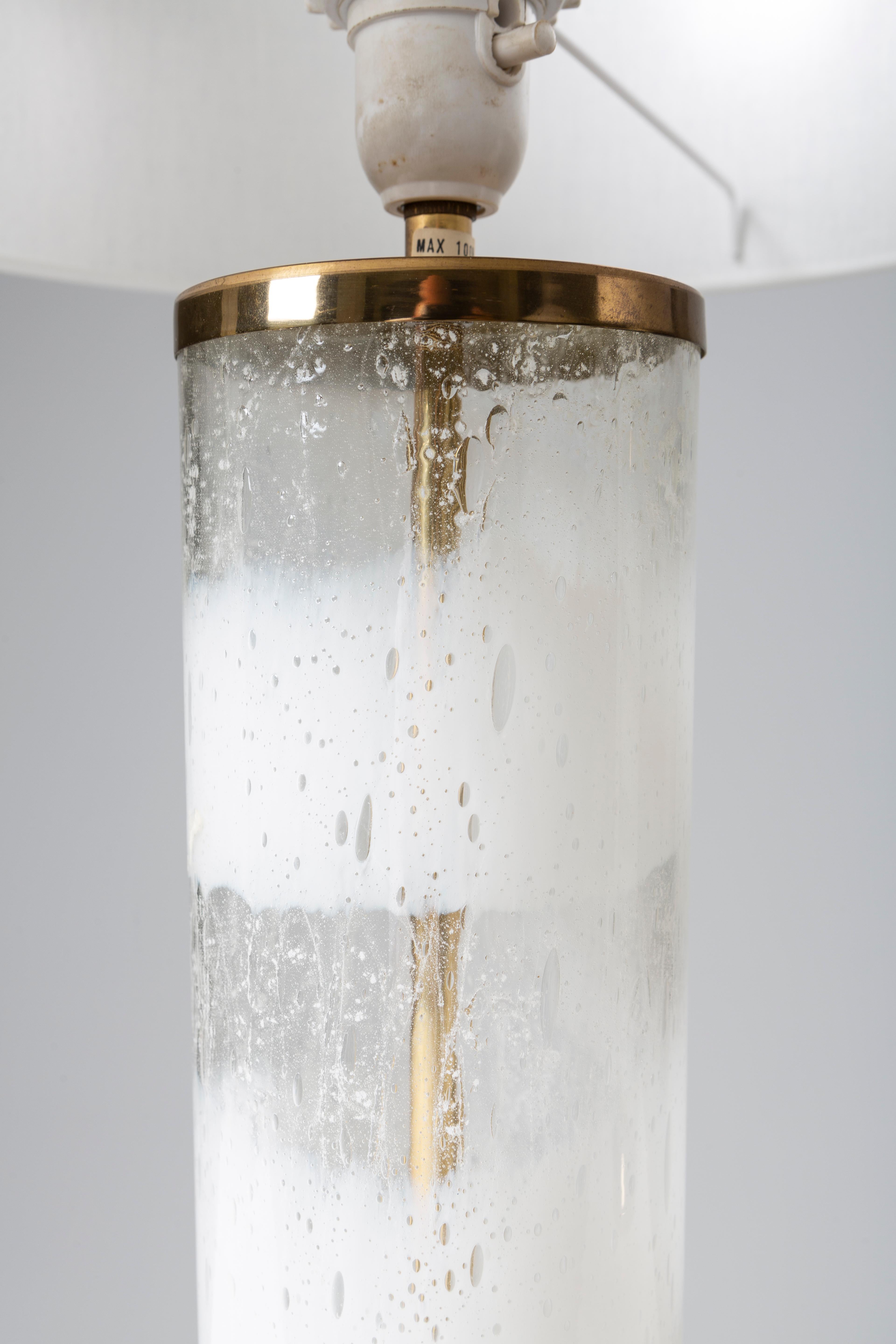 Pair of lamps in clear and white glass. Produced by Bergboms in Sweden around 1970. 
Dimensions of the lamp body: height 45cm. Diameter 11cm.
No chips or cracks.