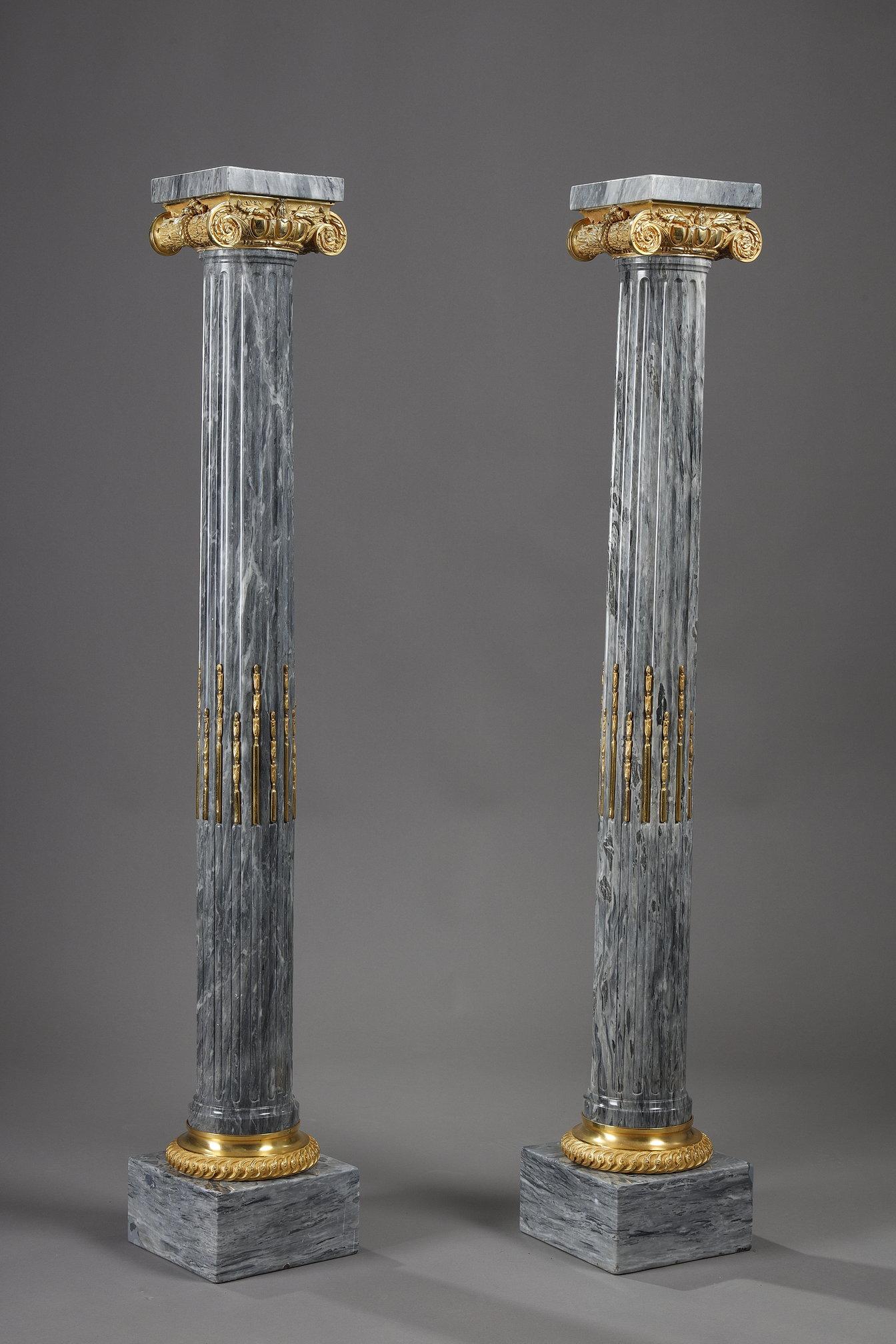 Large pair of grey veined marble columns, fluted, filleted and with ormolu Ionic capitals. The square top is 18 cm square.
