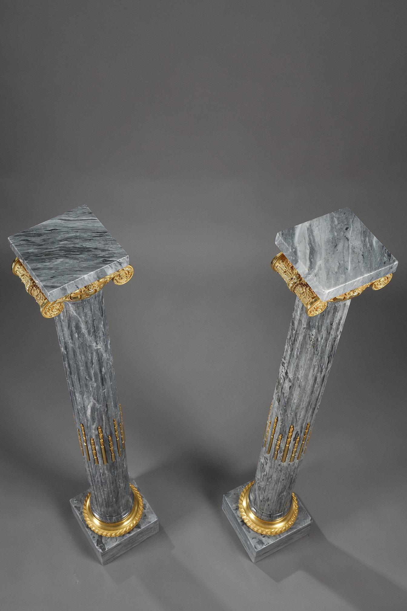 Large pair of grey veined marble columns, fluted, filleted and with ormolu Ionic capitals. The square top is 18 cm square.
