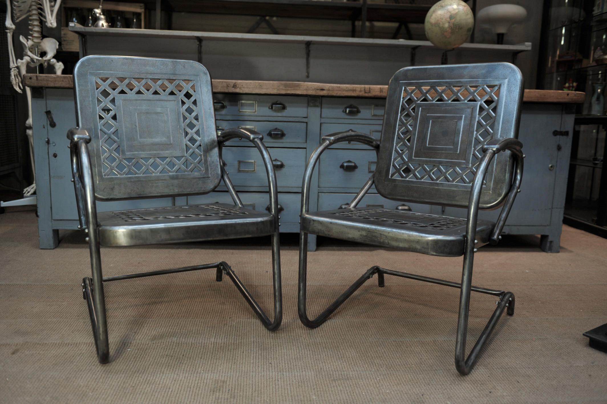Pair of perforated metal garden armchairs or chairs, 1950s. Polished finish all in very good condition.