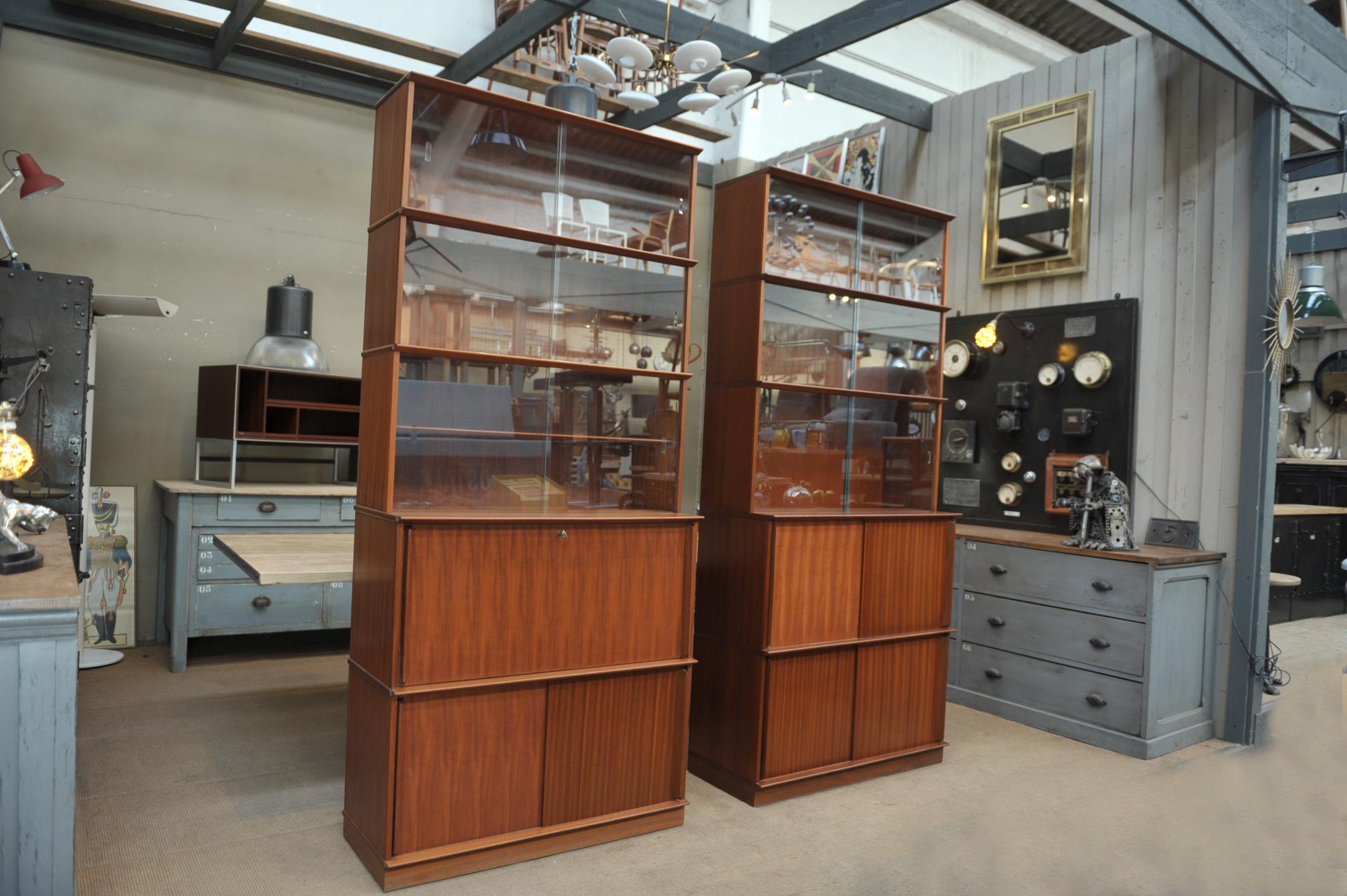 Pair of teak sliding glass doors cabinets. Each one is 5 elements of height 16.54 inches (42 cm) put one over the other and can be changed or not use as you want. Height with 4 elements is then 66.55 inches (169 cm).
One bottom is secretaire front