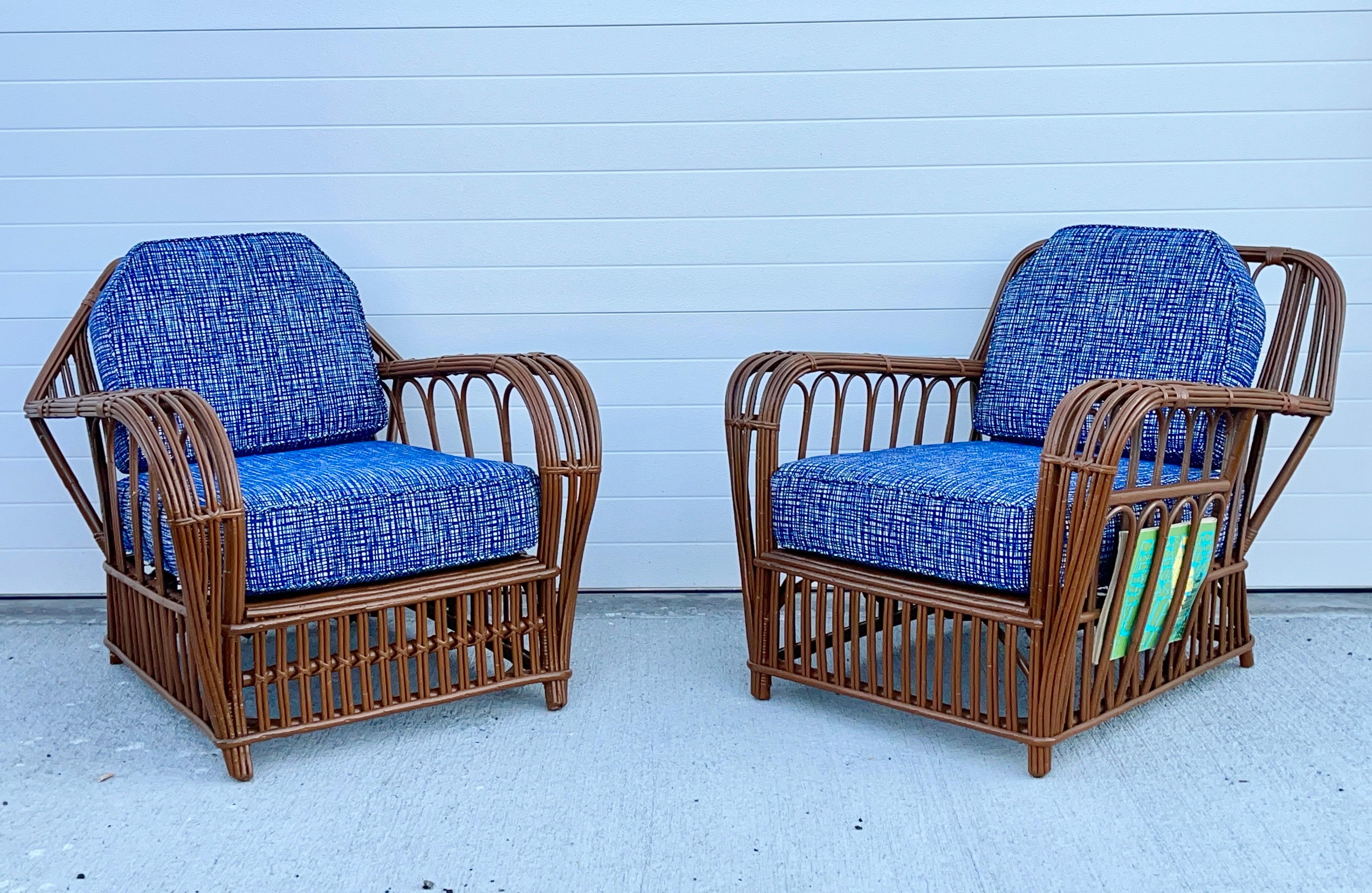 Set of two American art deco stick reed rattan armchairs.  One with tombstone back.  One with square (rectangular) back; this one also has a side pocket for newspapers and Country Life.
Both newly restored, refinished and new custom cushions in