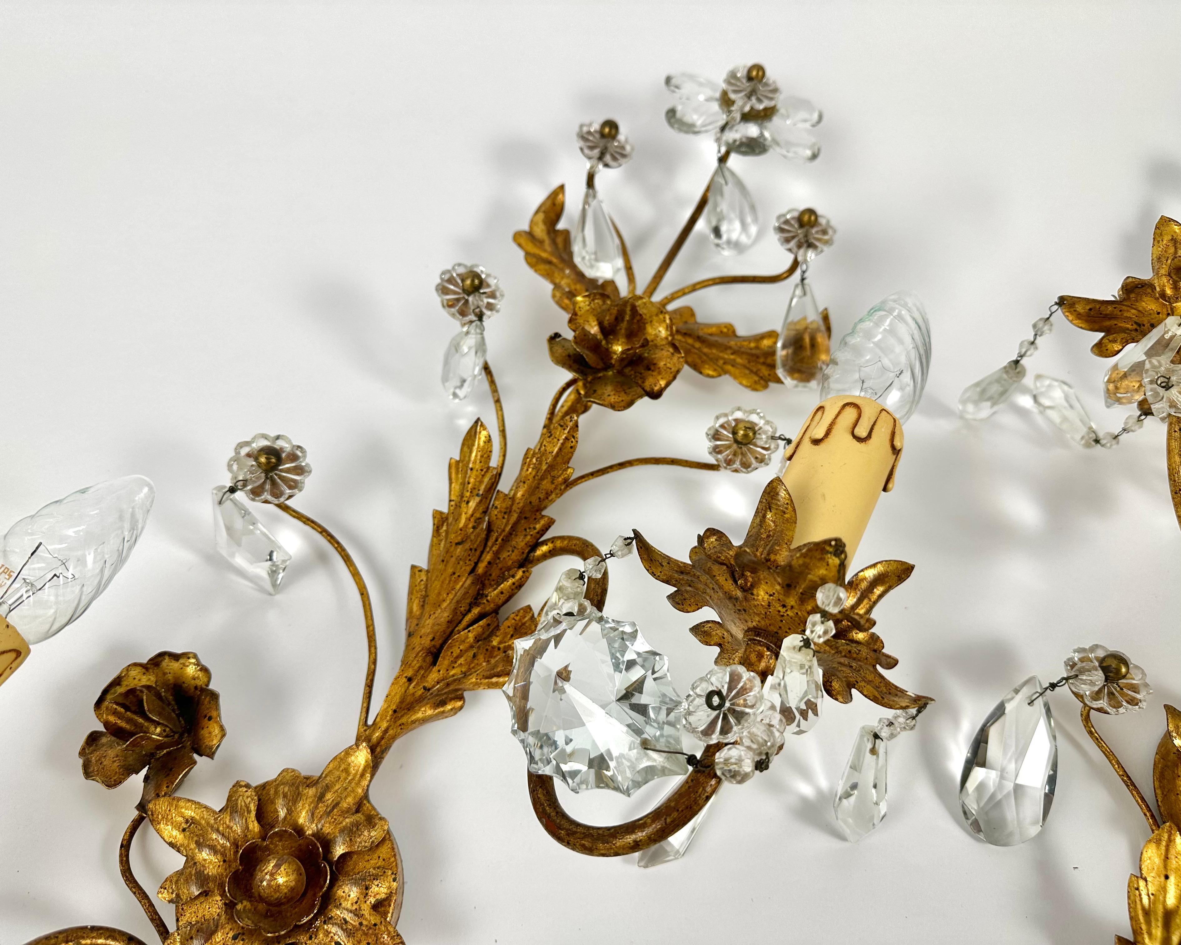 Beautiful Large Florentine Sconces from the 1950s with two bases on each, featuring crystal daisy flowers and golden curved leaves.

Manufactured in Italy.

Very nice design with lots of details and high quality processing.

The whole sconce is made