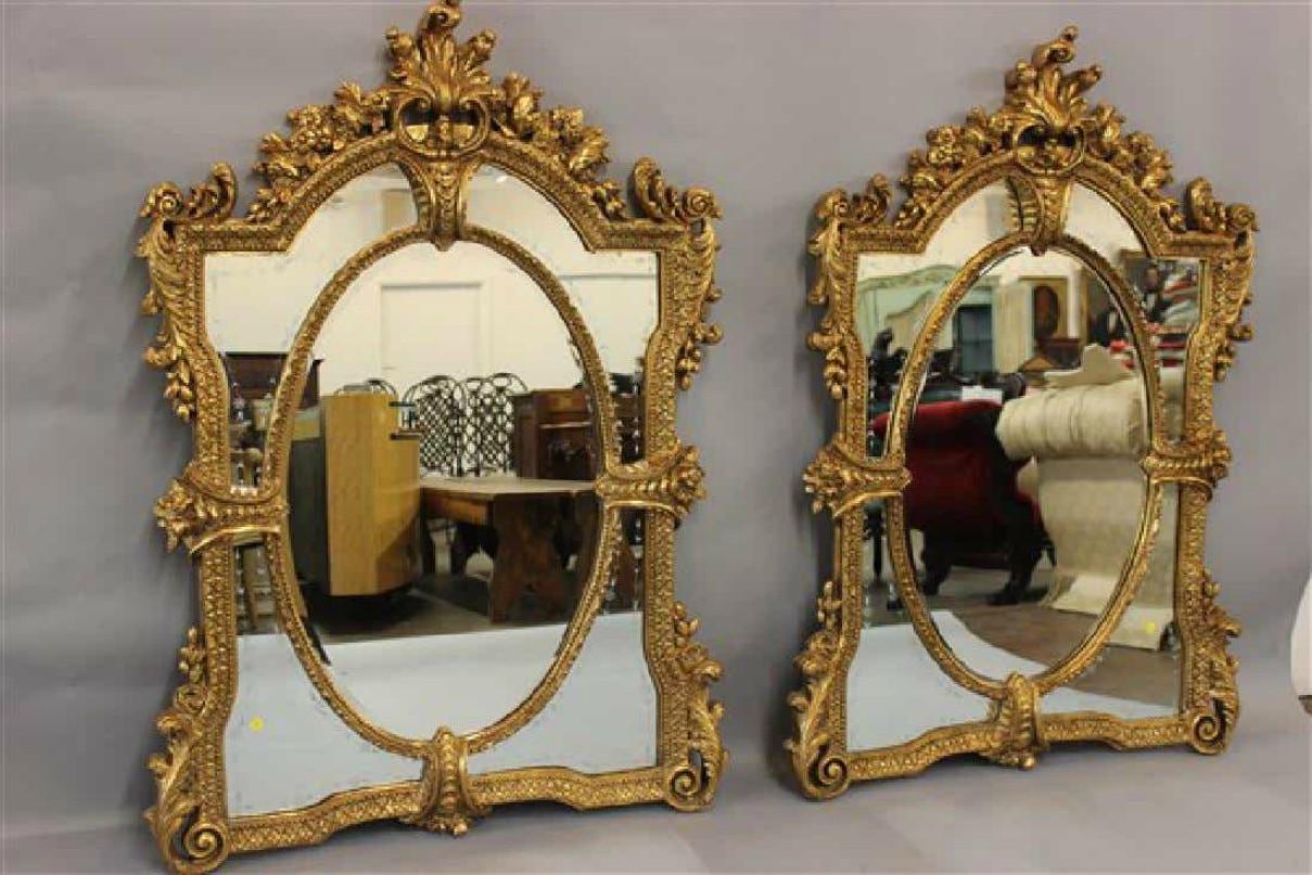 Pair of monumental Venetian gold gilt carved framed etched glass wall mirrors. These palatial wall or console mirrors are simply spectacular in form. The large and impressive frames with scroll, floral and shell design flanking a border of