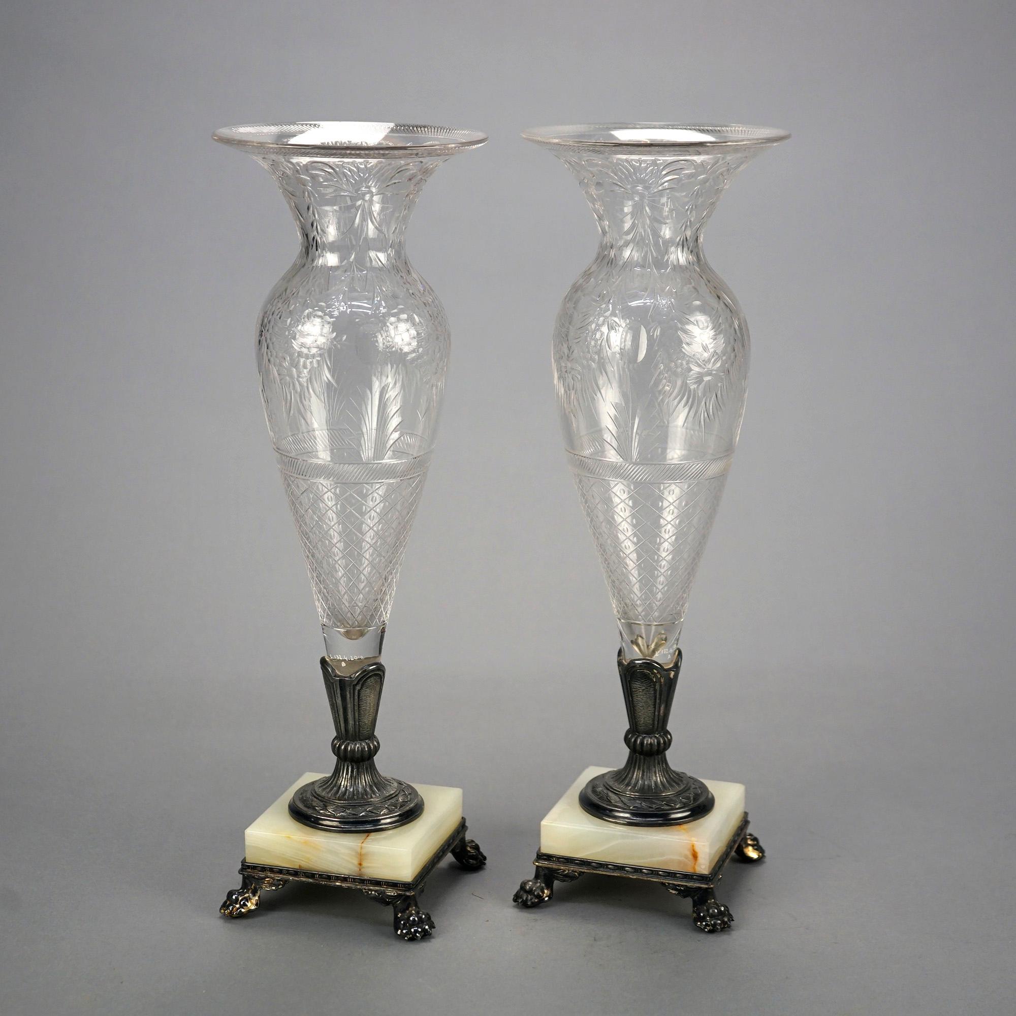 An antique pair of vase by Pairpoint offer crystal vessels having etched floral, foliate and diamond pattern seated in silver plate bases with onyx platforms and cast paw feet, maker signed as photographed, c1900

Measures- 14.5'' H x 5'' W x 5''