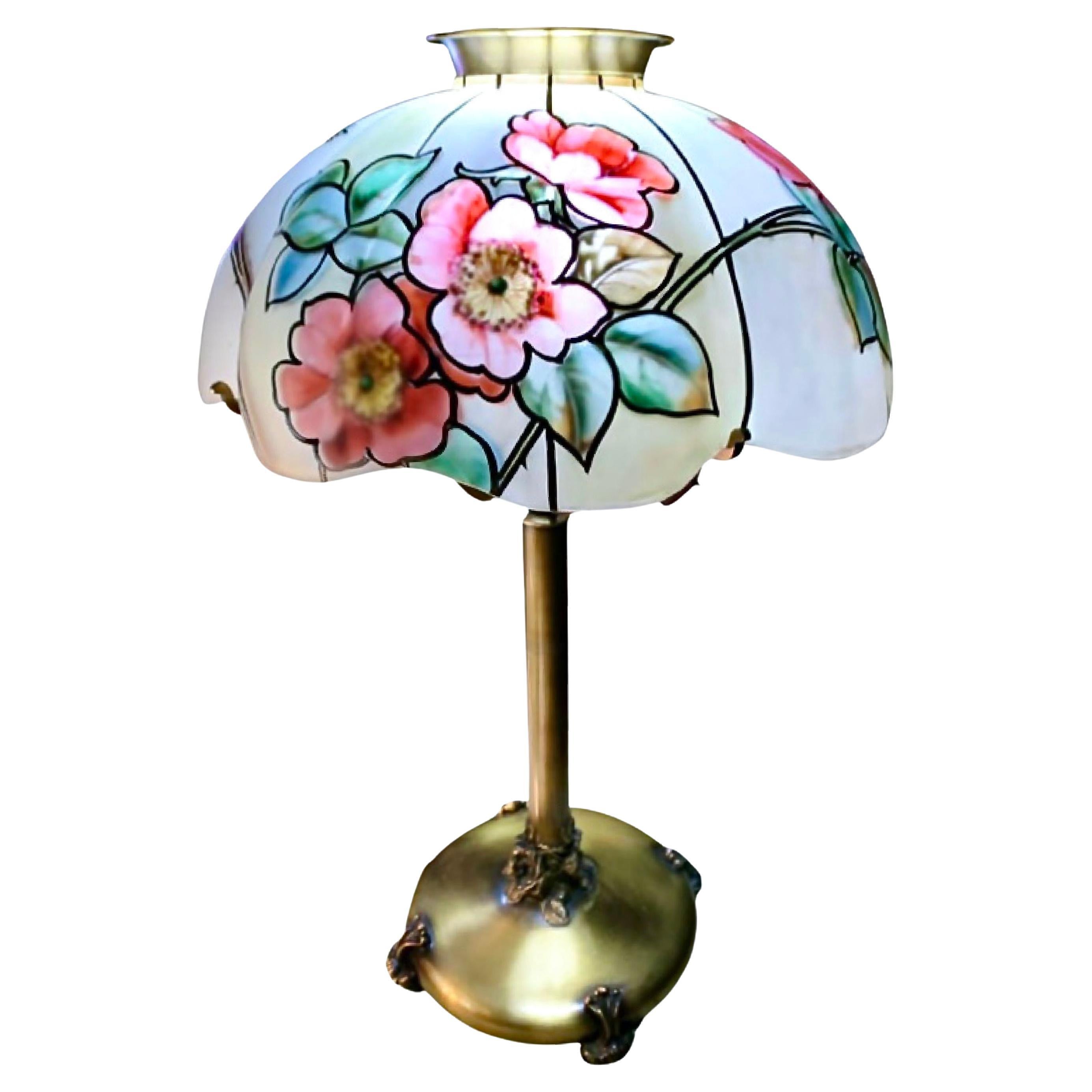 Pairpoint Glass Co. rose floral stained glass table lamp, Vienna shade, circa 1915, reverse-painted and enameled frosted glass, patinated metal
lamp features Plymouth shade with roses. Stamped manufacturer's mark to base 'Pairpoint MFG Co. P 3093'.