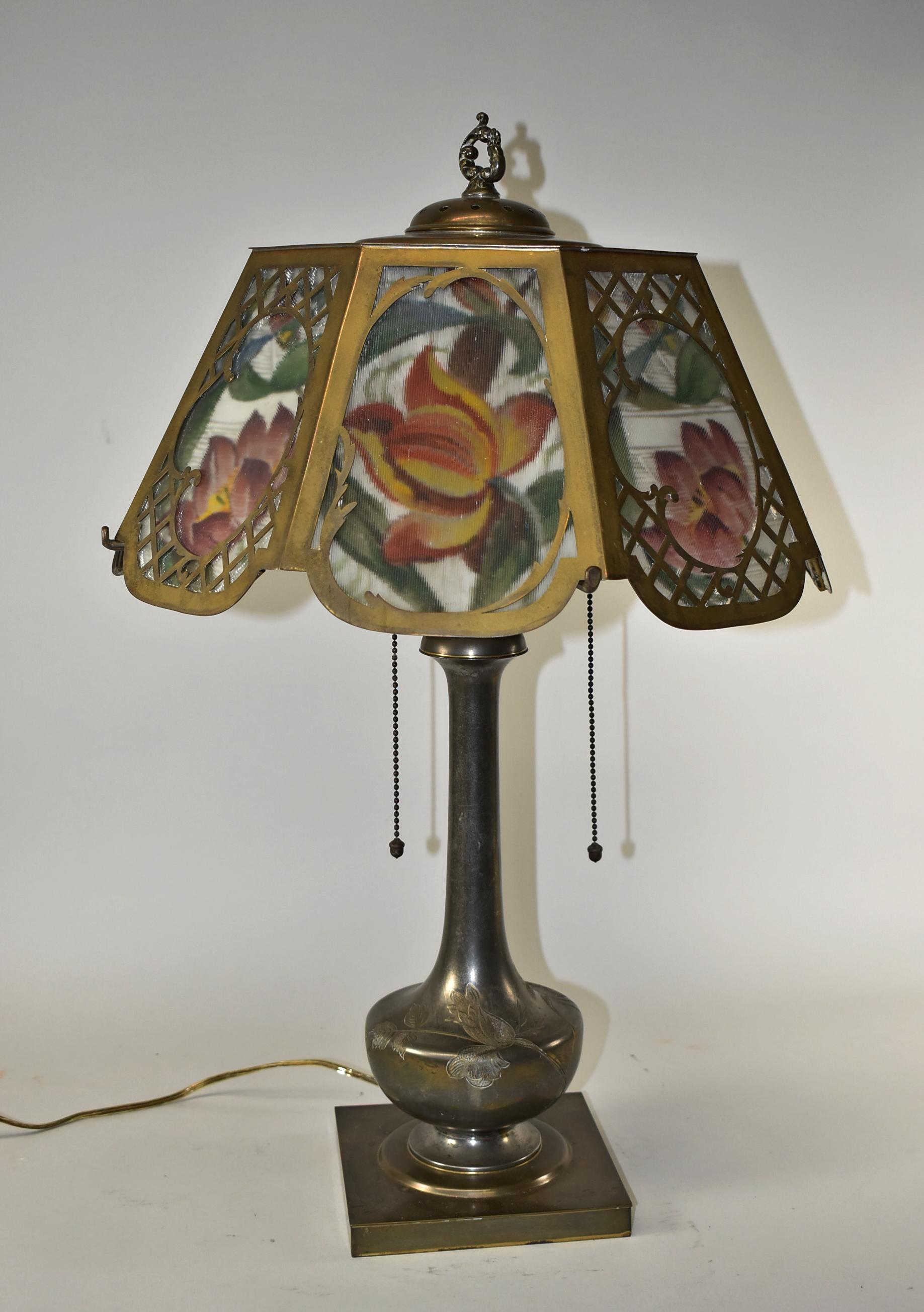 Pairpoint reverse painted eight panel table lamp. Two sockets with acorn pulls on silver plated engraved foliage base. 16
