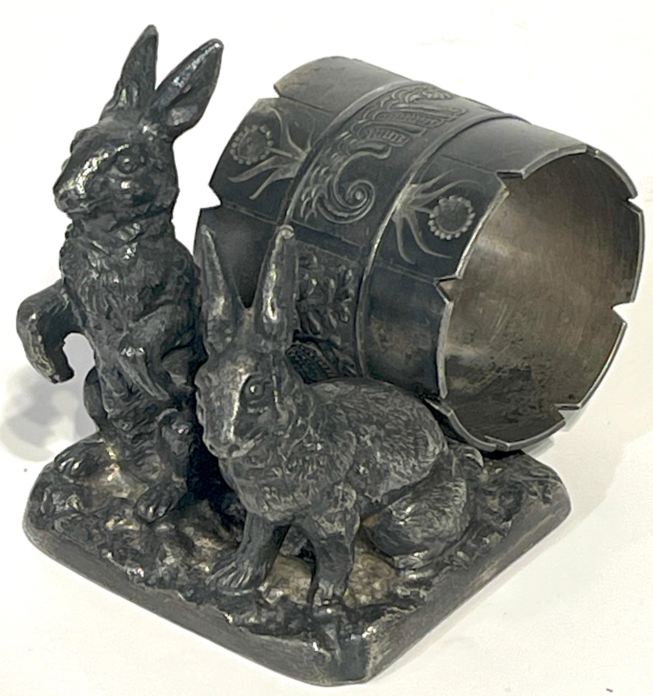 Versilberter figuraler Serviettenring 'Double Rabbits' mit Paar Punkten 
Pairpoint MFG Co. New Bedford, MA, um 1890

Für Sammler von exquisitem Geschirr ist dieser figurale Serviettenring von Pairpoint aus dem Jahr 1890 ein seltener Fund. Messen