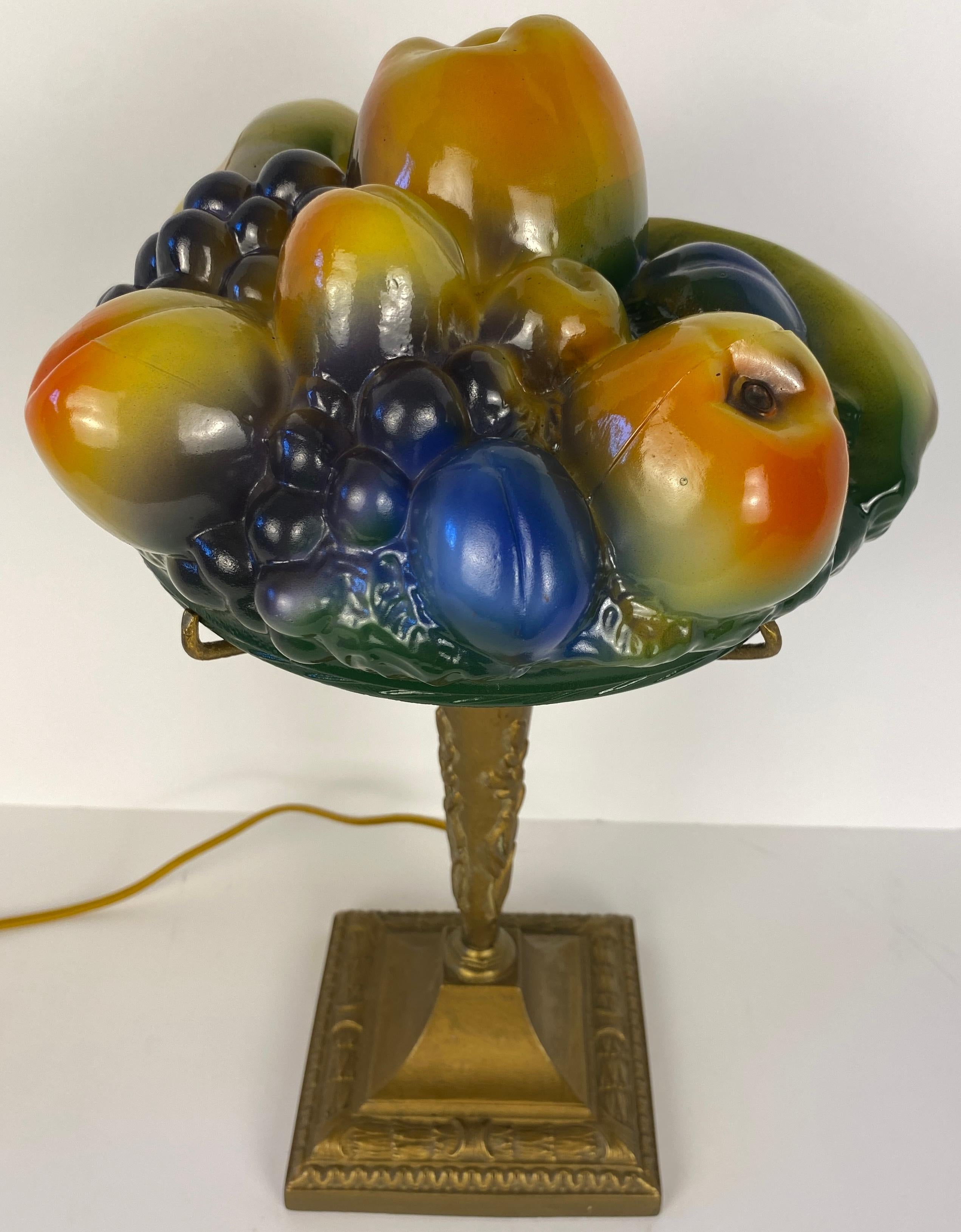 Pairpoint style molded glass table lamp.  

Presenting a splendid Art Deco Pairpoint style table lamp. The frosted glass dome shade pressed/molded glass, air-brushed polychrome is in very well preserved antique condition on a scroll footed brassed