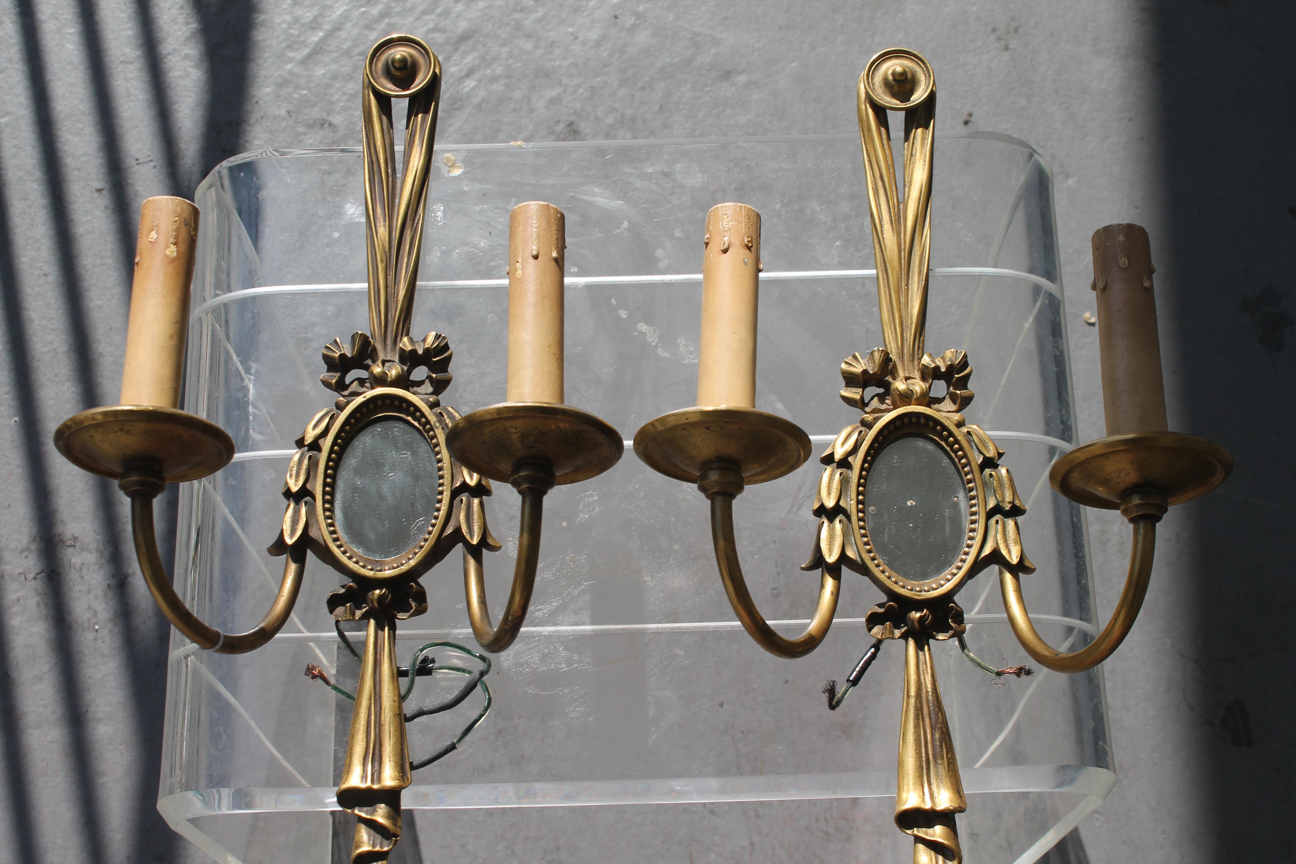 French Pairr c1913 E.F. Caldwell Louis XVI style Bronze Drape with Mirror Wall Sconces For Sale