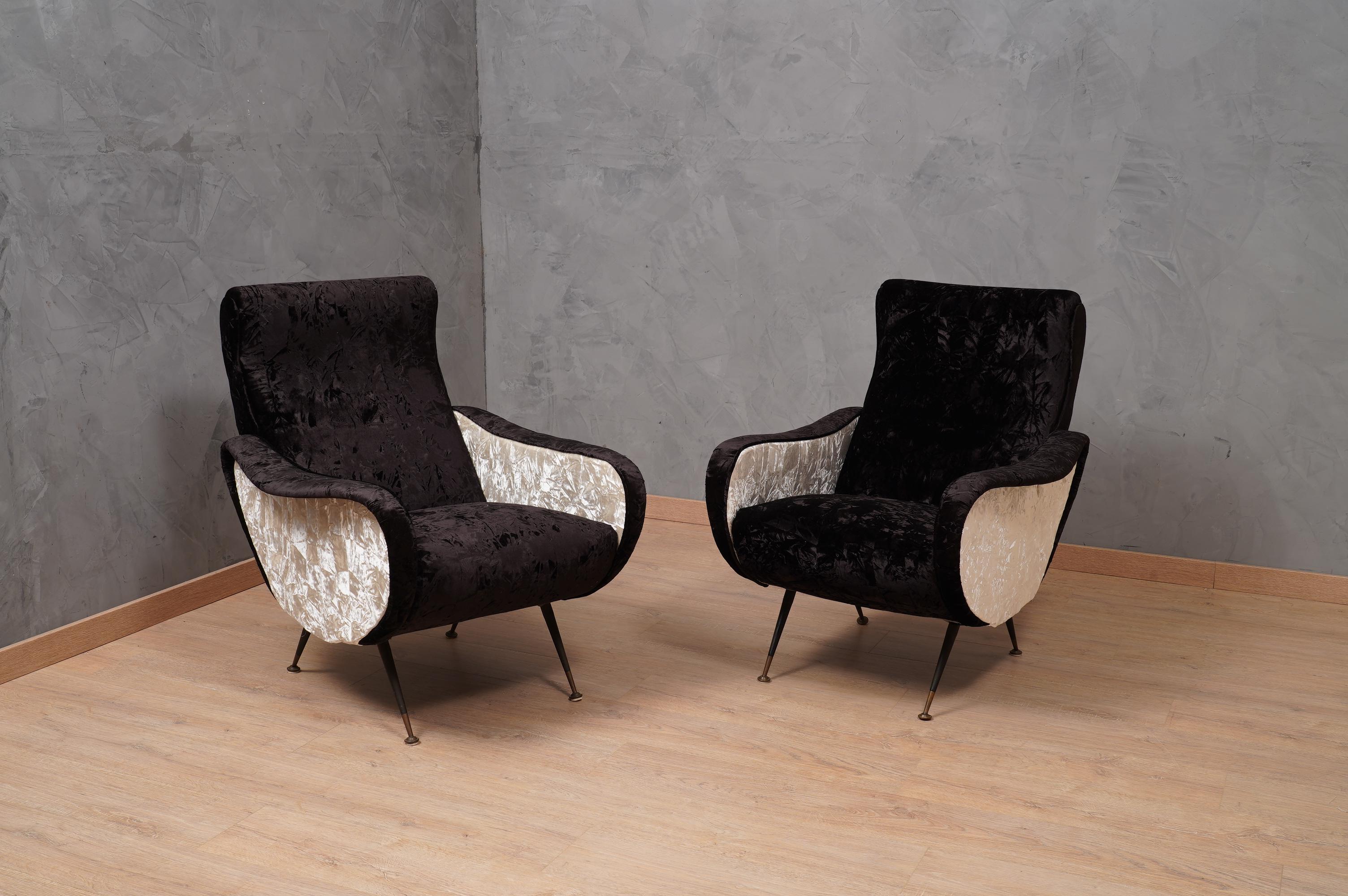 A revisitation of a Classic and famous pair of Italian armchairs full of charm, embellished with a marriage of a fine velvet.

The armchairs have been renovated with a combination of two velvet fabrics. Two crumpled velvets were used, one in black