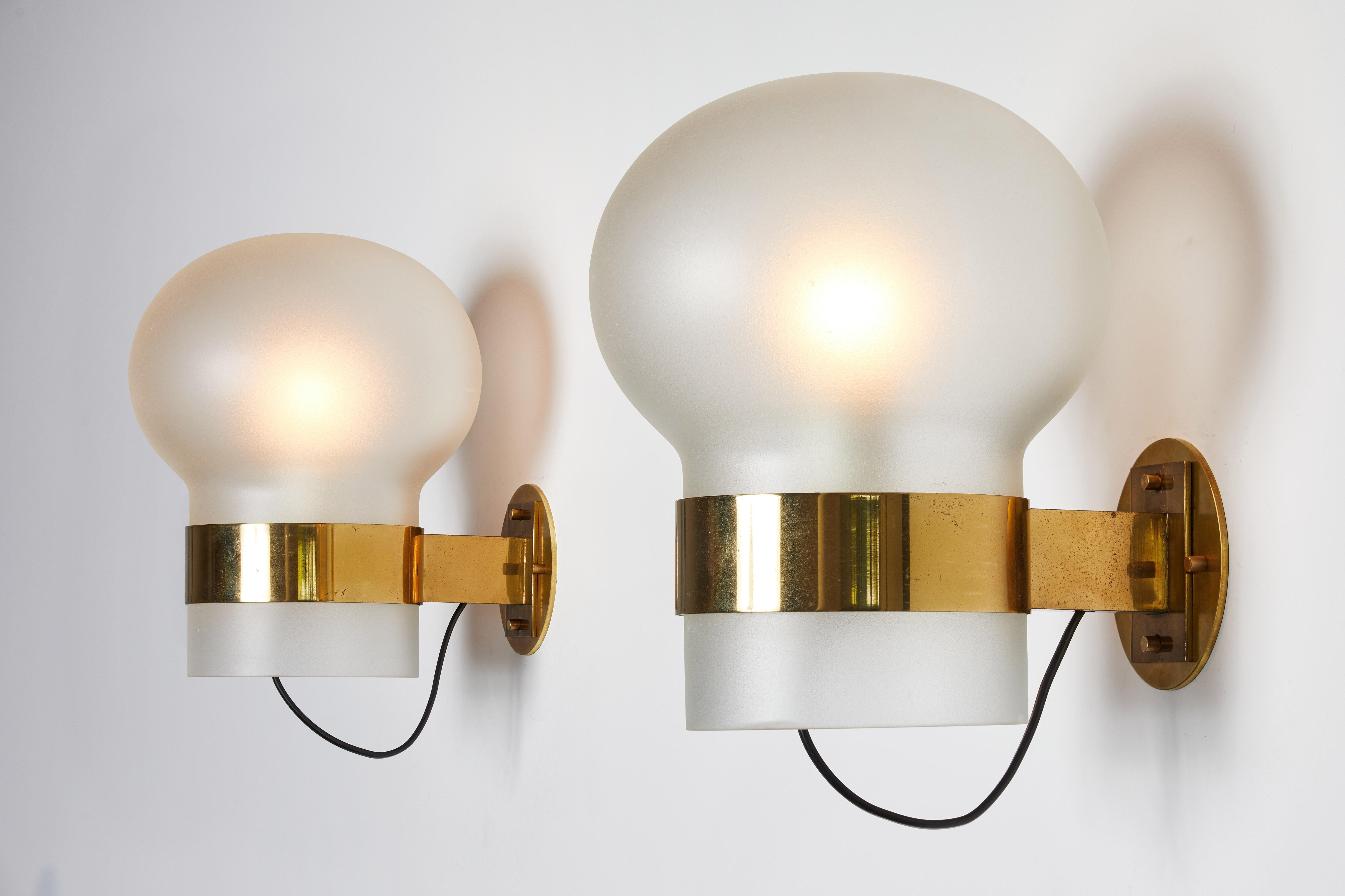 Pair of Model 2404 Sconces by Fontana Arte. Designed and manufactured in Italy, circa 1950s. Rewired for U.S. junction boxes. Frosted textured opaline glass globe with brass hardware. Custom backplates. Each globe takes one E27 60w maximum globe.