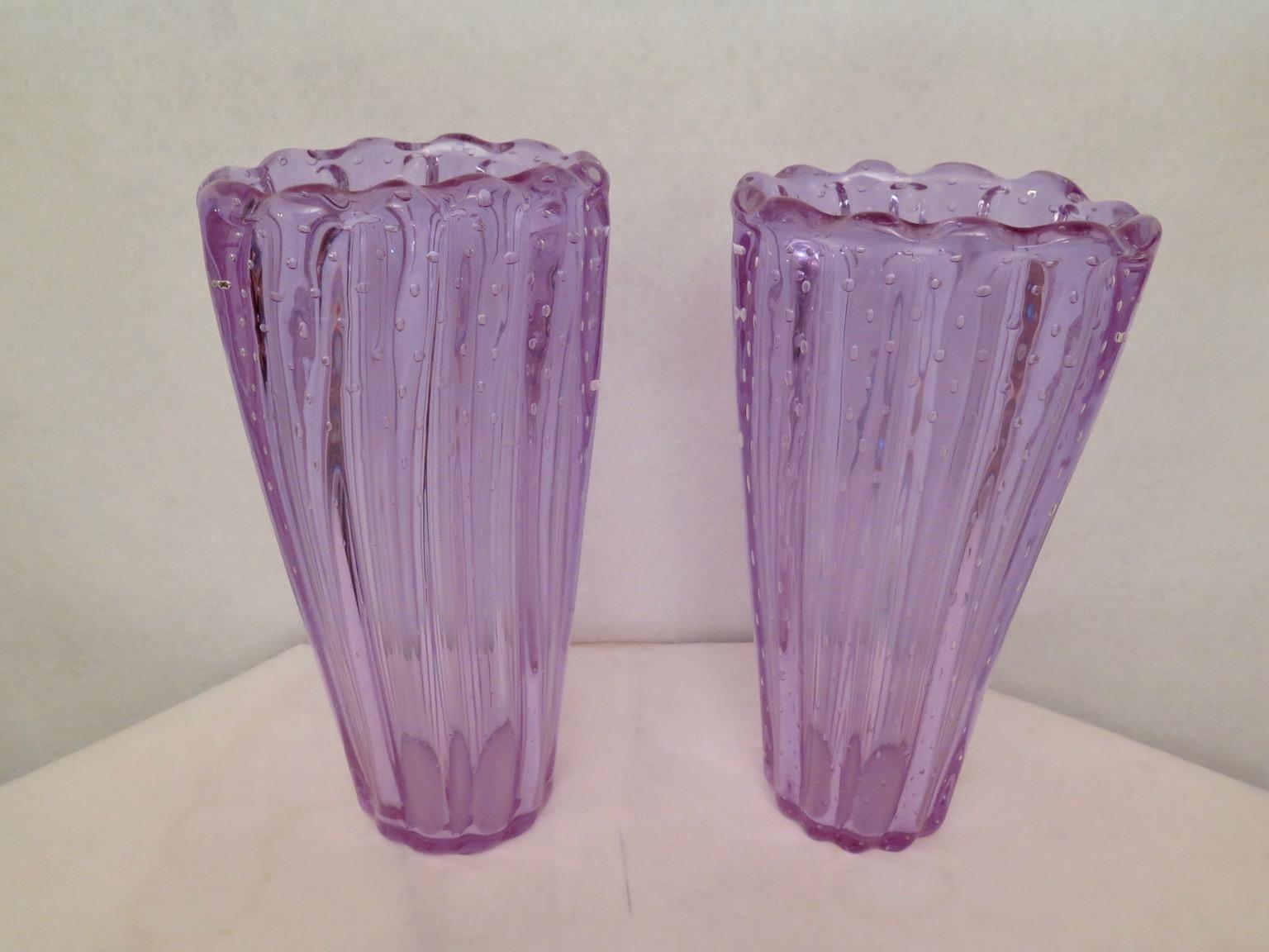 Pairs of Murano midcentury art glass vases, precious both the color and the type of workmanship.

All Murano glass, violet / transparent color. The vases are ribbed, as can be seen from the photos. The part of the base is slightly narrower than