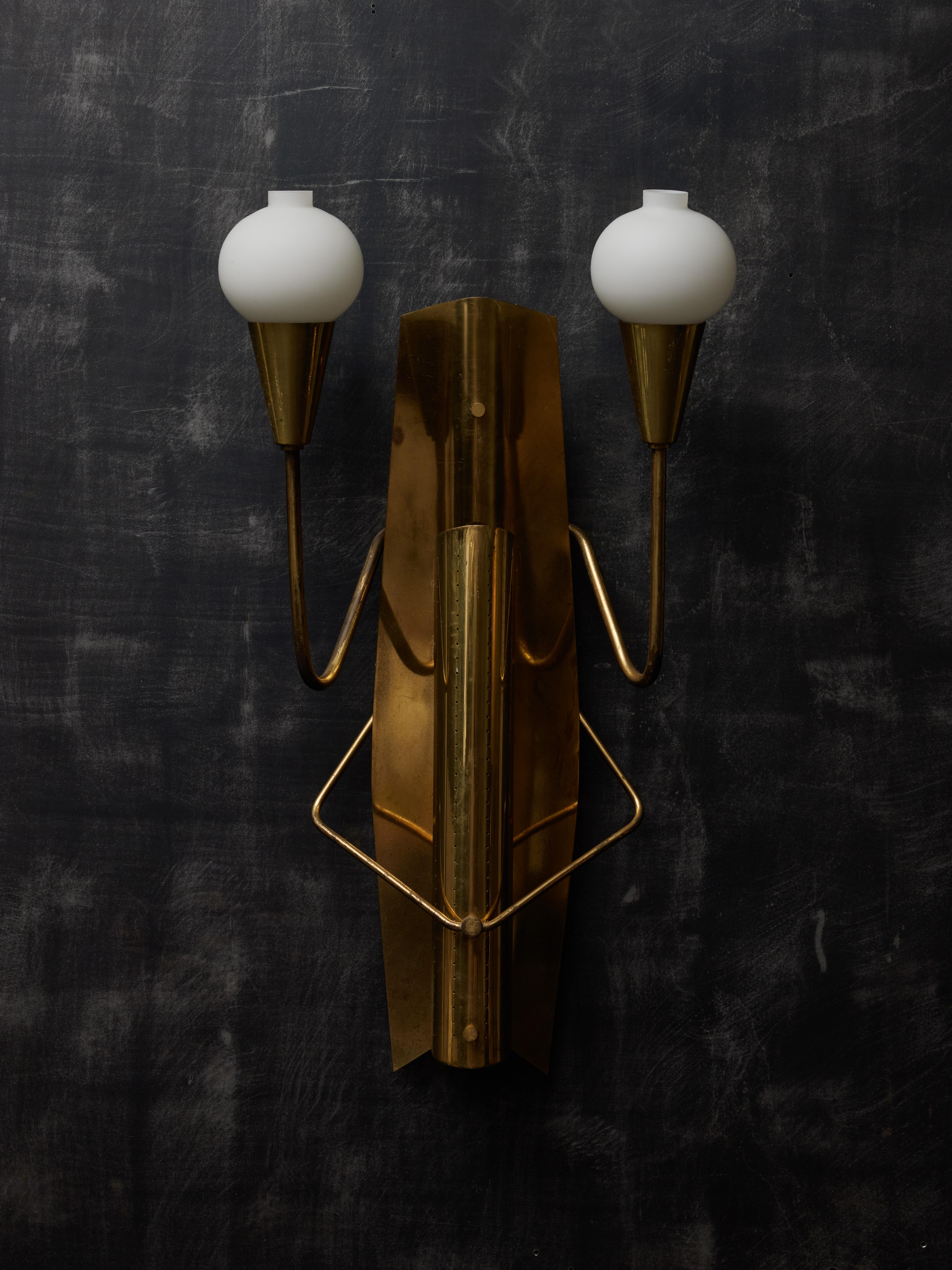 Pair of vintage brass and opaline glass globes wall sconces, which shape reminds us of a grasshopper. These sconces were hung since 1954 in a movie theatre in Norway.

