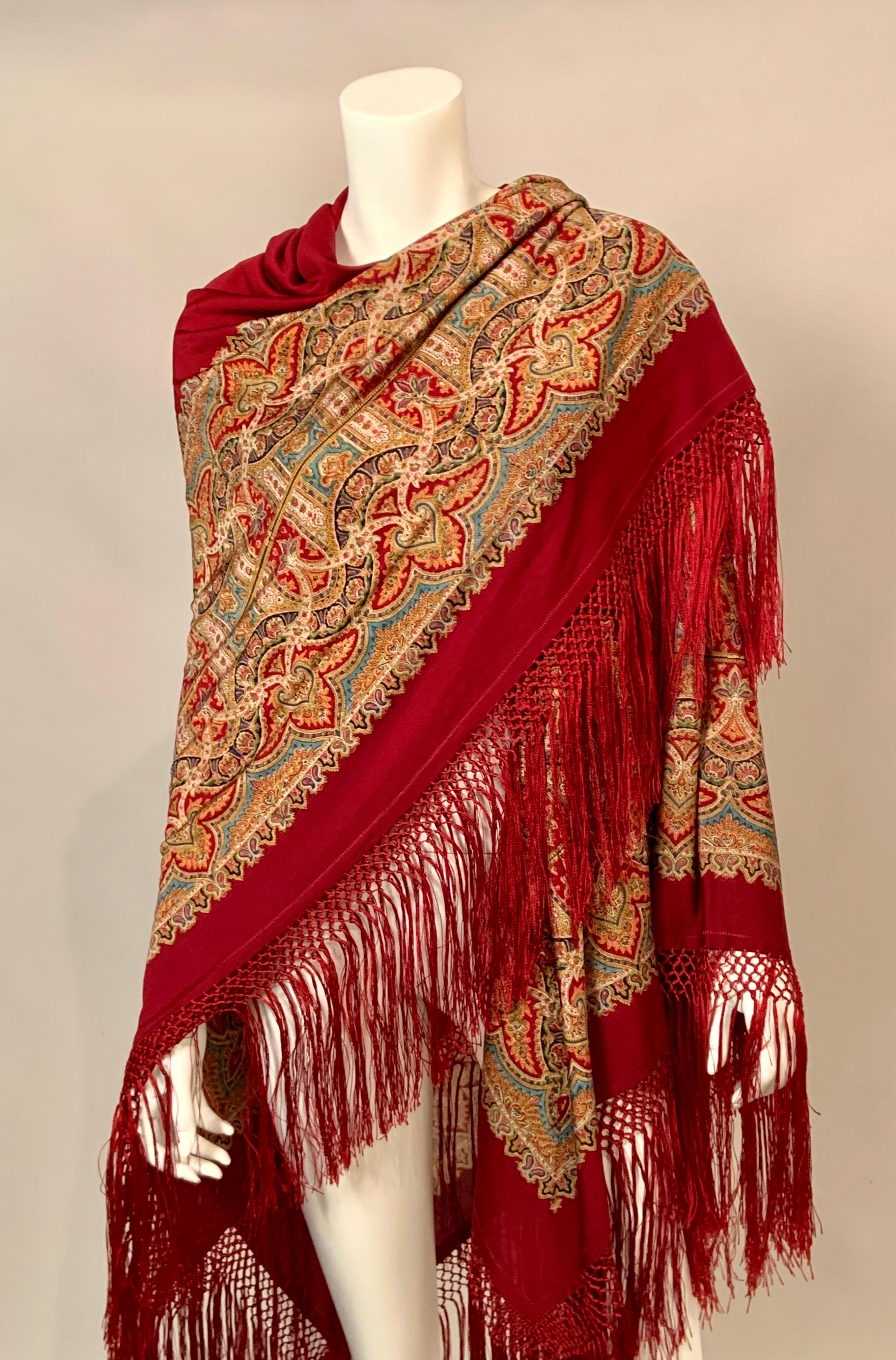 A beautiful rich burgundy red shawl has a 14