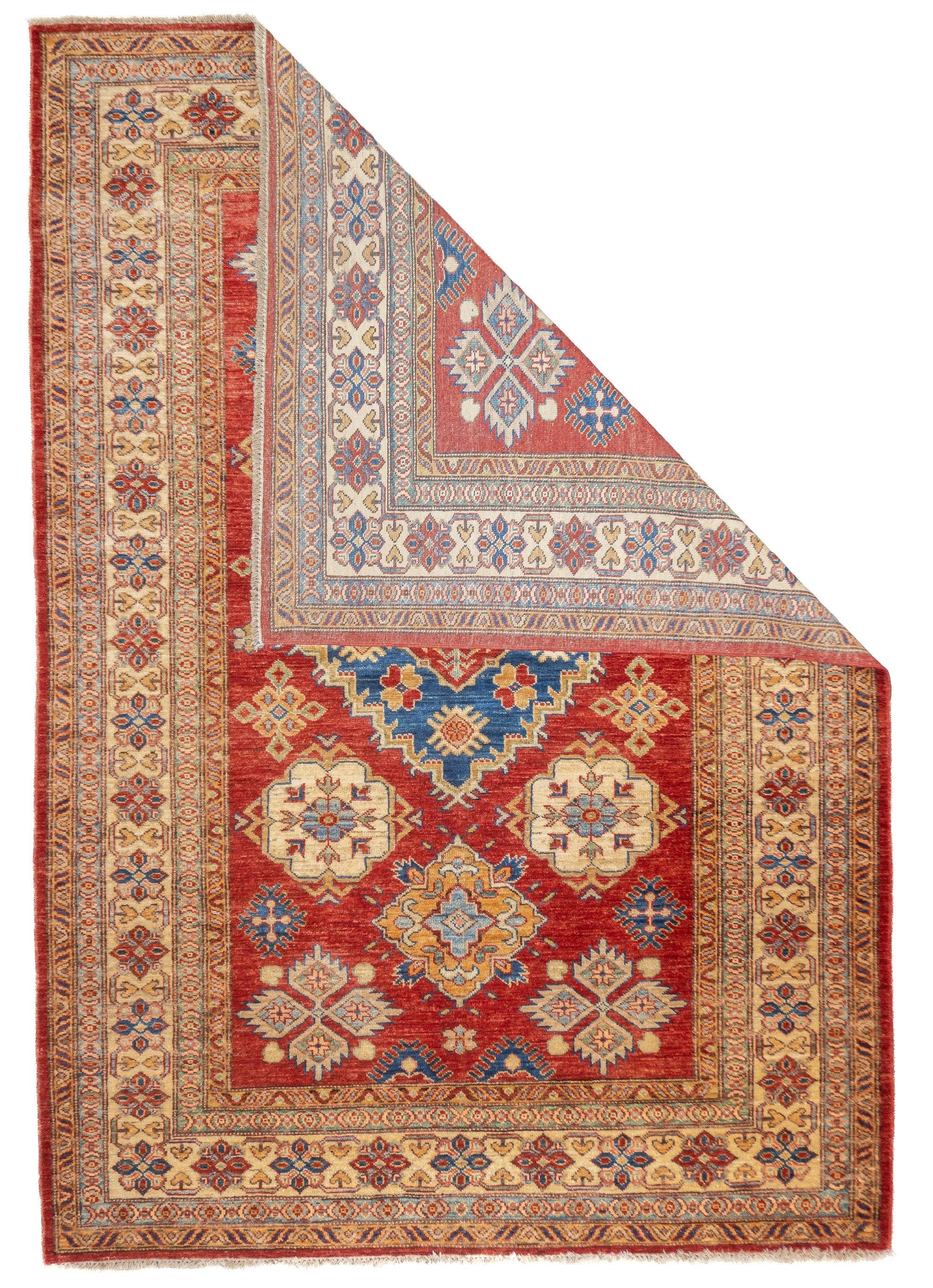 PAK Kazak Rug 4'11'' x 7'2''. Pakistani post-WWII rug, generally scatters, with soft wool and curvilinear Persianate designs. Synthetic dyes, cotton foundations. Moderate to medium weaves.