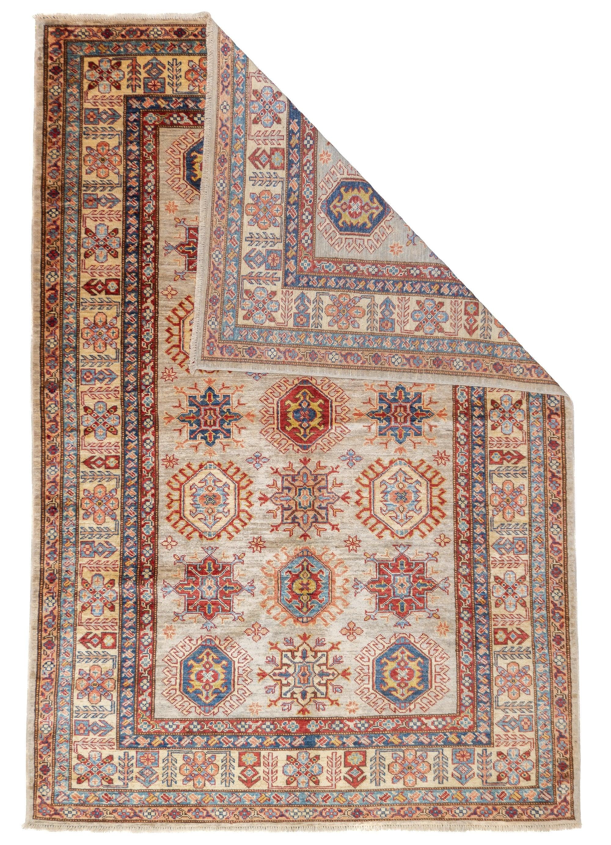 PAK Kazak Rug 4'11'' x 7'3''. Pakistani post-WWII rug, generally scatters, with soft wool and curvilinear Persianate designs. Synthetic dyes, cotton foundations. Moderate to medium weaves.