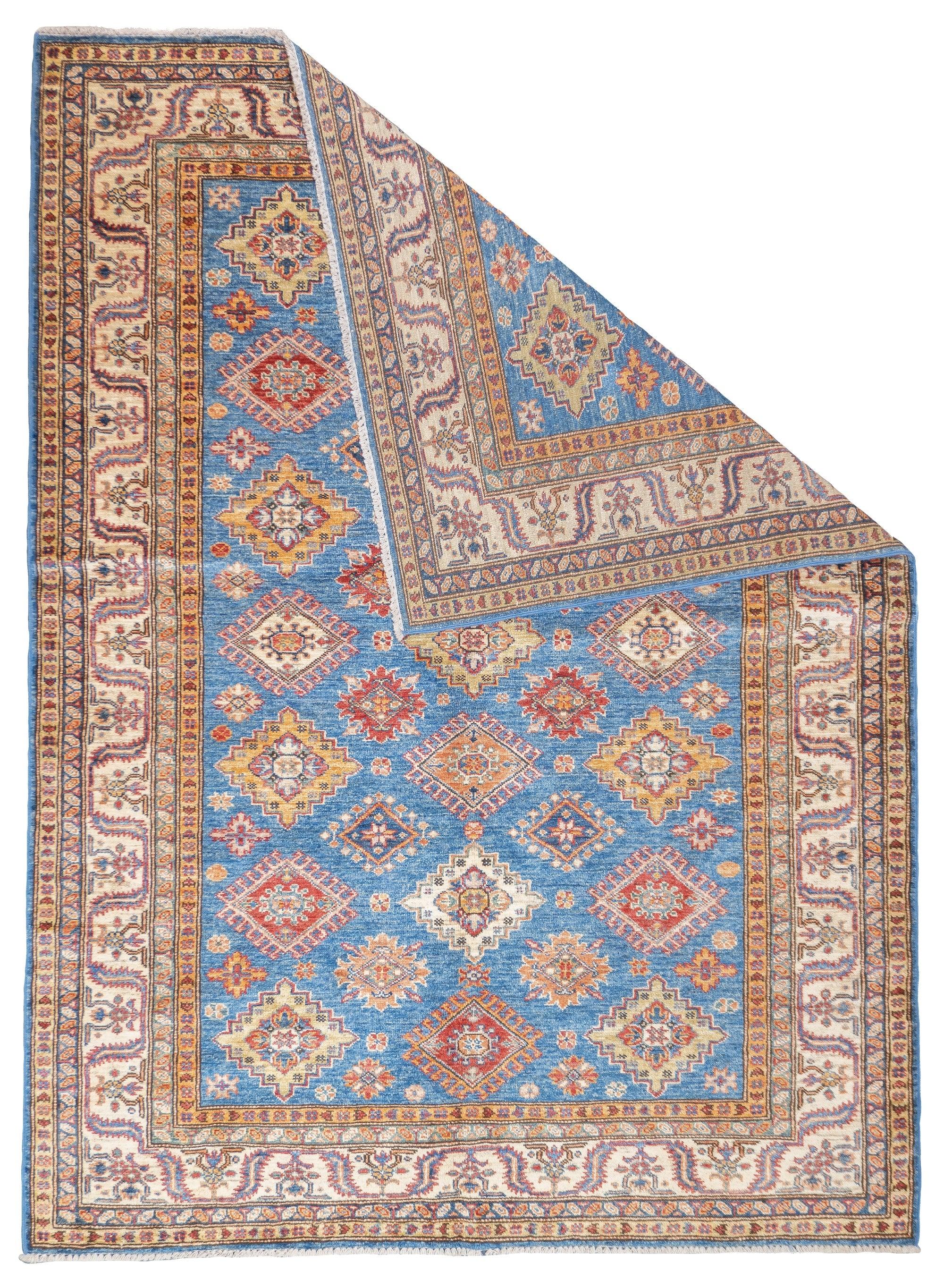 PAK Kazak Rug 5'1'' x 6'11''. Pakistani post-WWII rug, generally scatters, with soft wool and curvilinear Persianate designs. Synthetic dyes, cotton foundations. Moderate to medium weaves.
