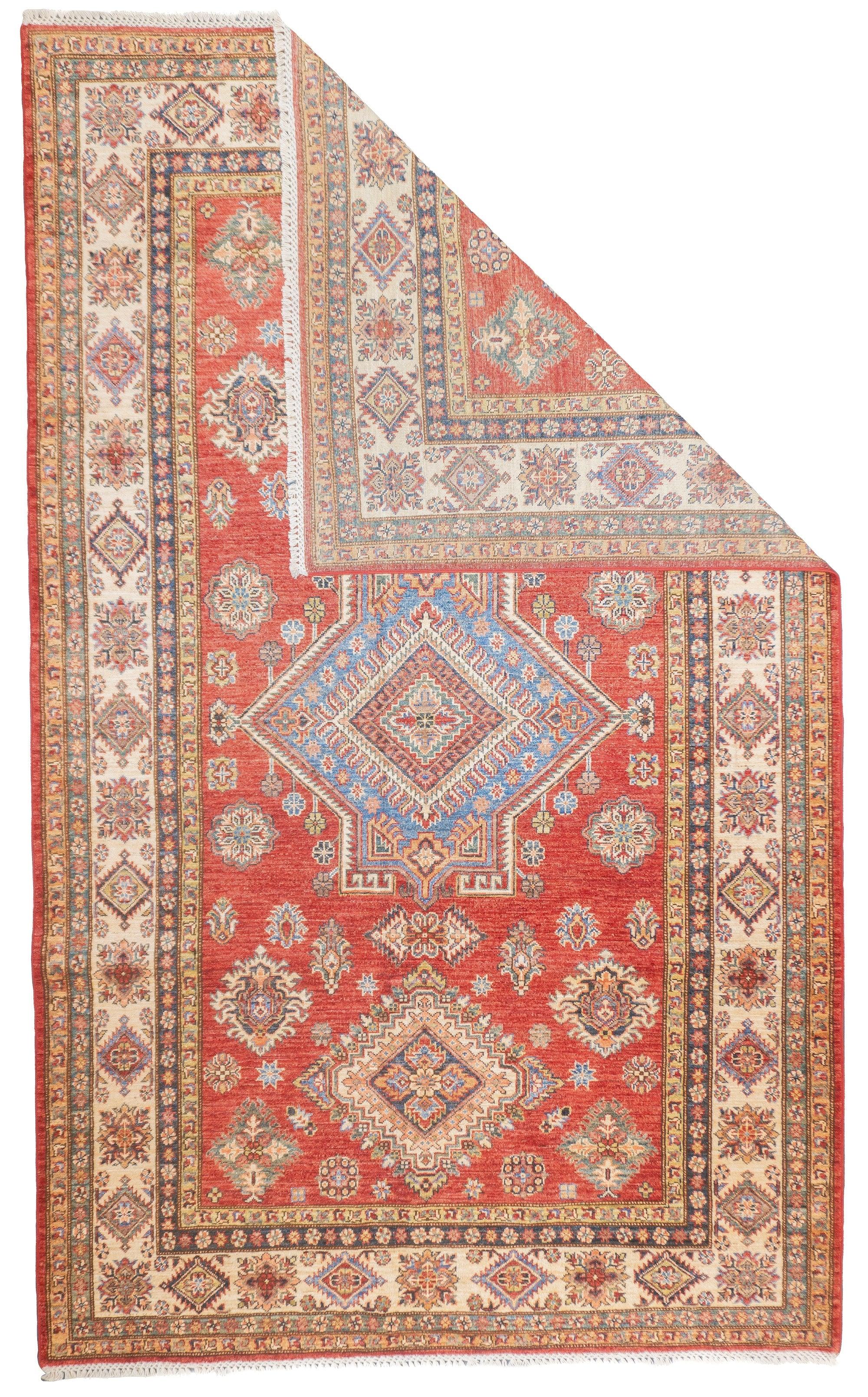 PAK Kazak Rug 5'10'' x 9'7''. Pakistani post-WWII rug, generally scatters, with soft wool and curvilinear Persianate designs. Synthetic dyes, cotton foundations. Moderate to medium weaves.