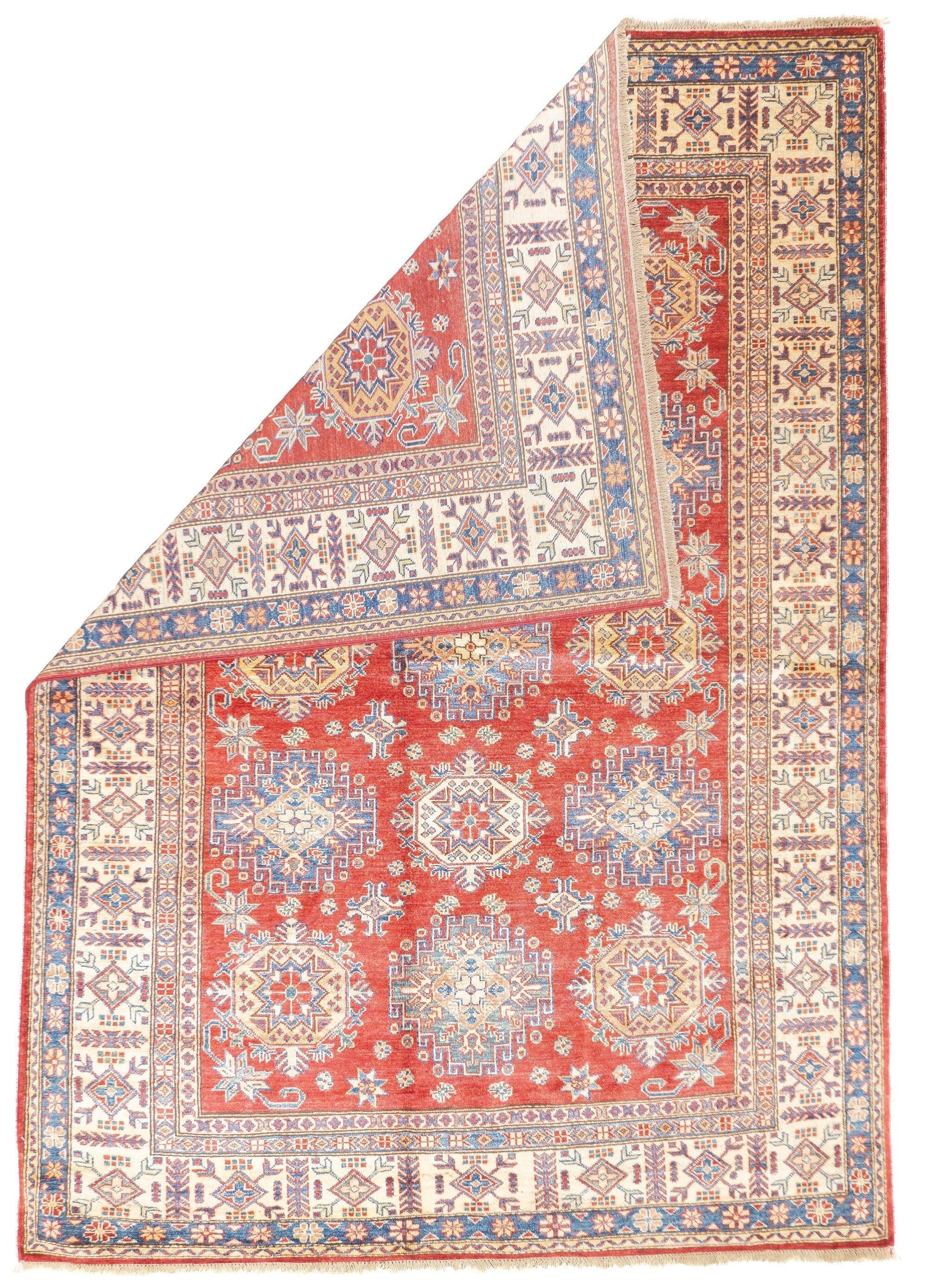 PAK Kazak Rug 5'6'' x 7'10''. Pakistani post-WWII rug, generally scatters, with soft wool and curvilinear Persianate designs. Synthetic dyes, cotton foundations. Moderate to medium weaves.