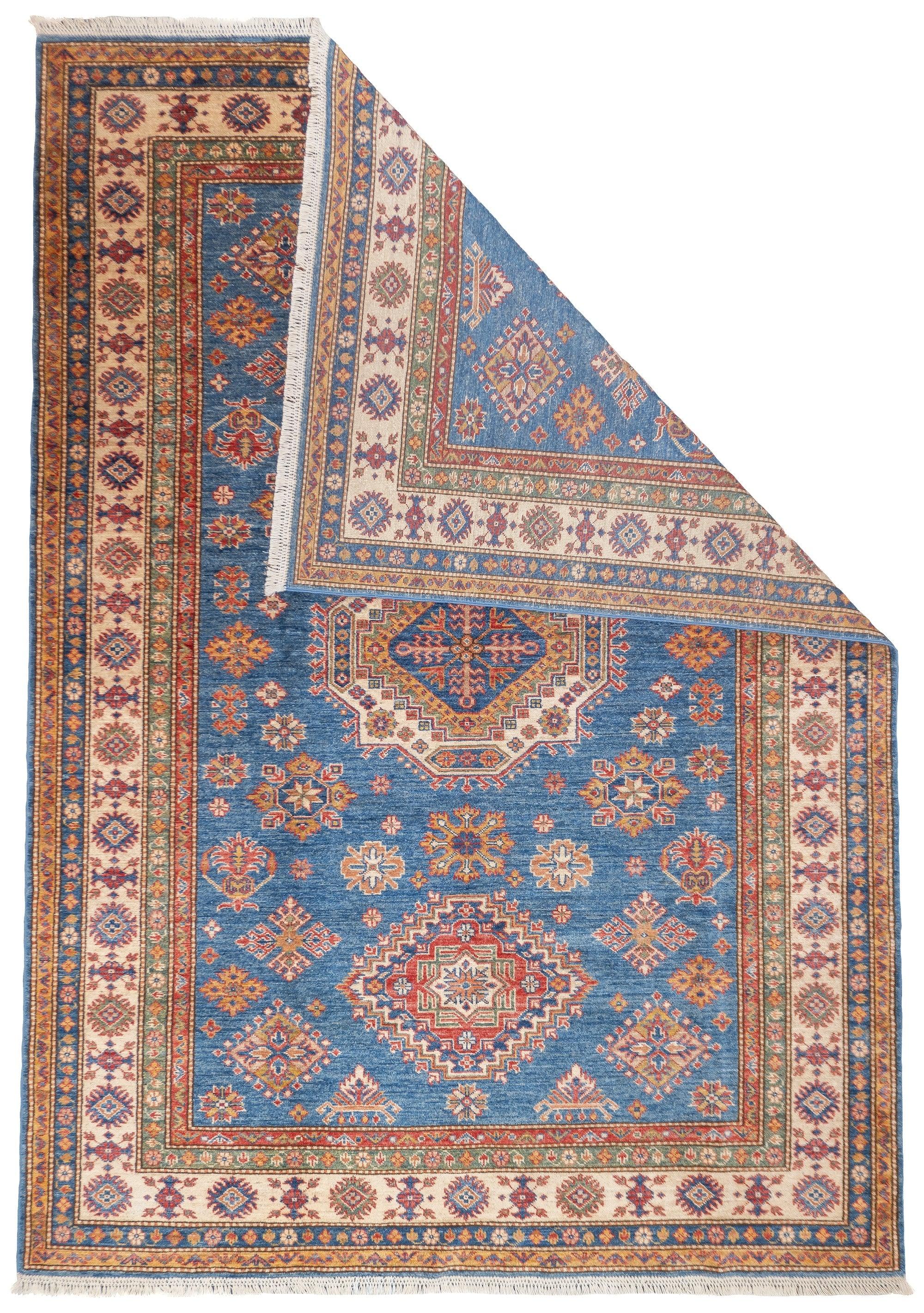 PAK Kazak Rug 5'9'' x 8'3''. Pakistani post-WWII rug, generally scatters, with soft wool and curvilinear Persianate designs. Synthetic dyes, cotton foundations. Moderate to medium weaves.