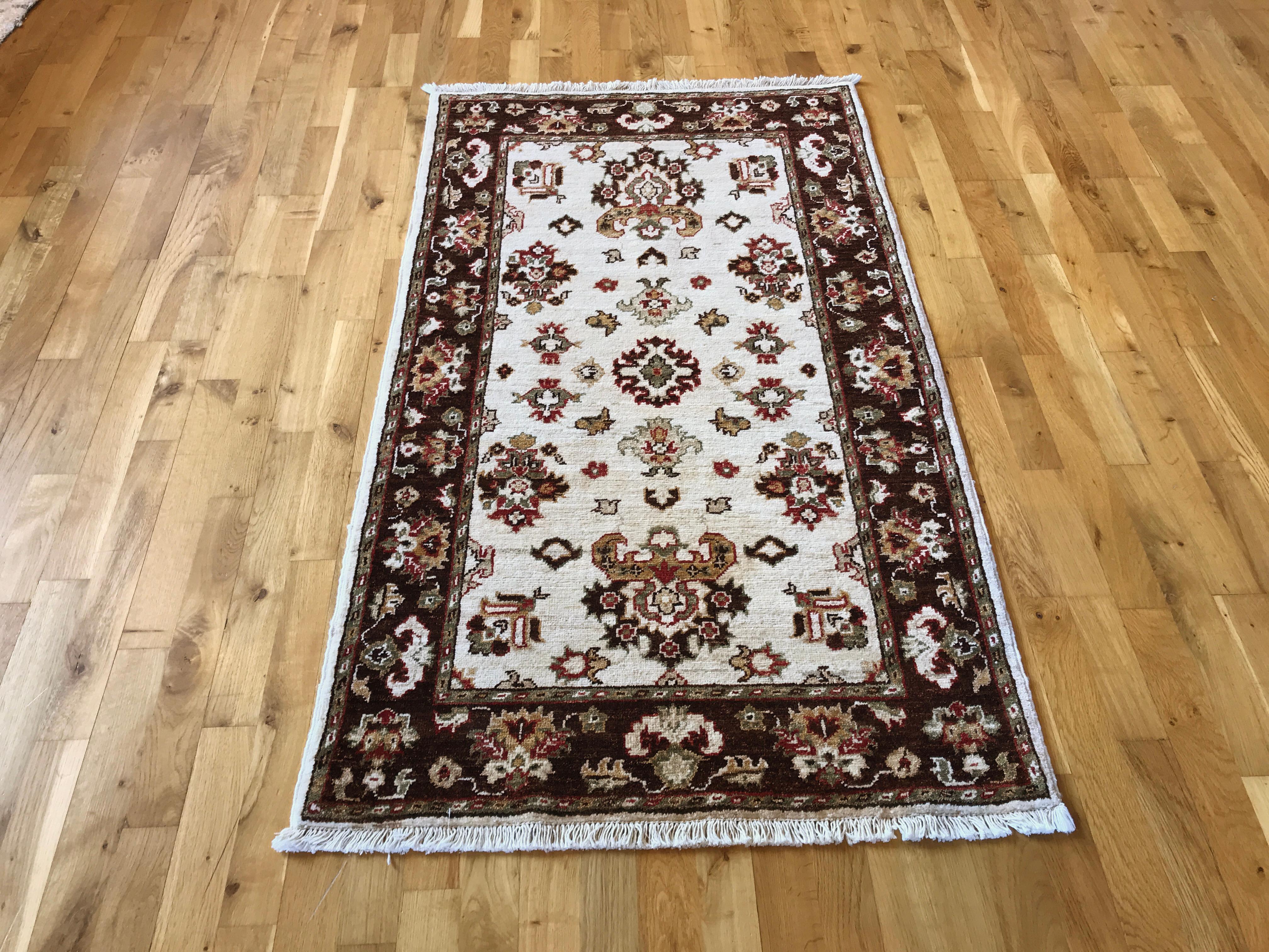 This hand-knotted wool rug was made in Pakistan and features a beautiful floral design in beige and brown. Crafted with expert precision, it adds a touch of elegance to any room while providing durability and comfort. A timeless addition to your