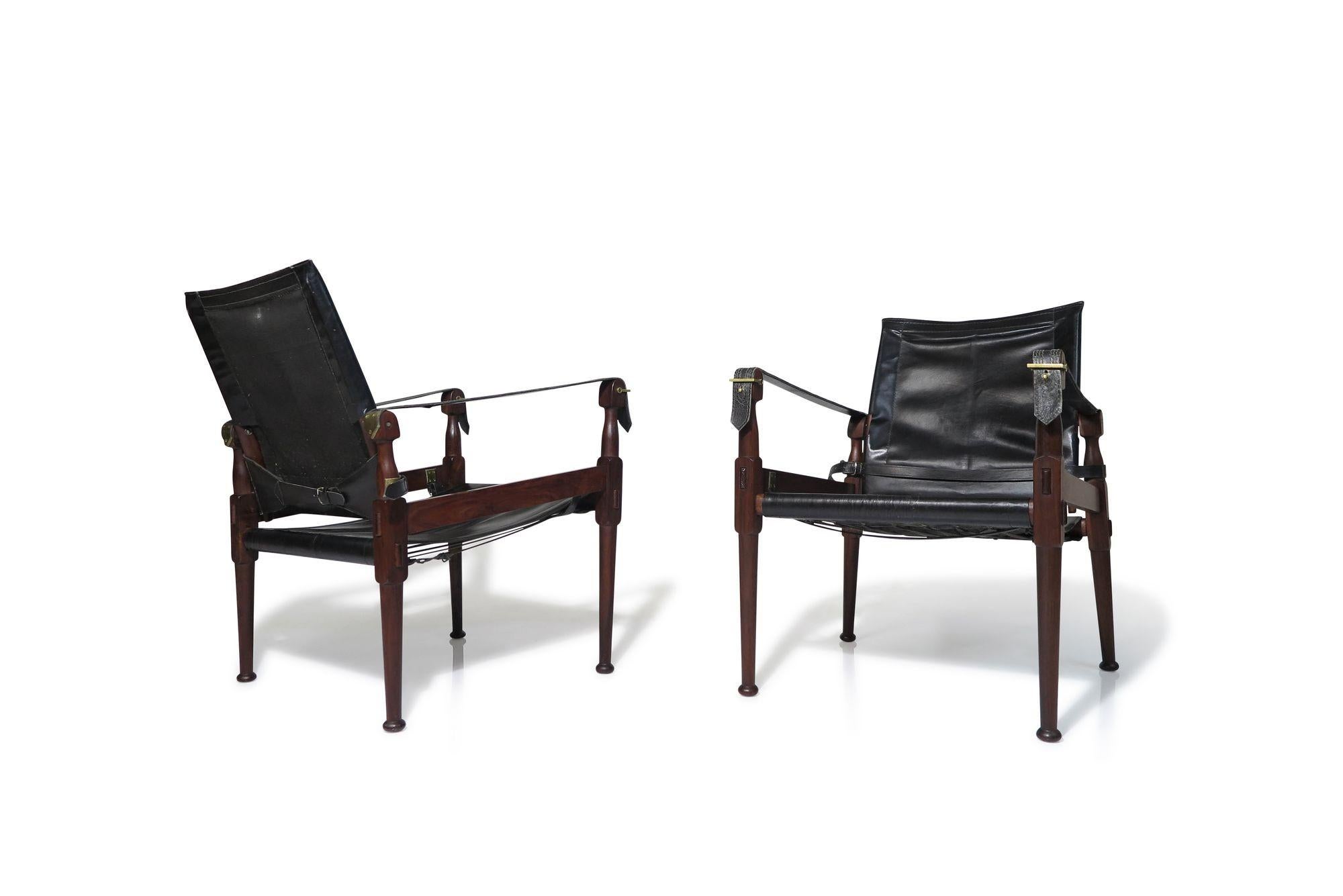 Safari chairs for Hayat Brothers, Pakistan, 1968.
The chairs are crafted of rosewood and black leather with brass details. Makers mark.

Measurements
W 21.25'' x D 27.25'' x H 29.5''
Seat Height 15''