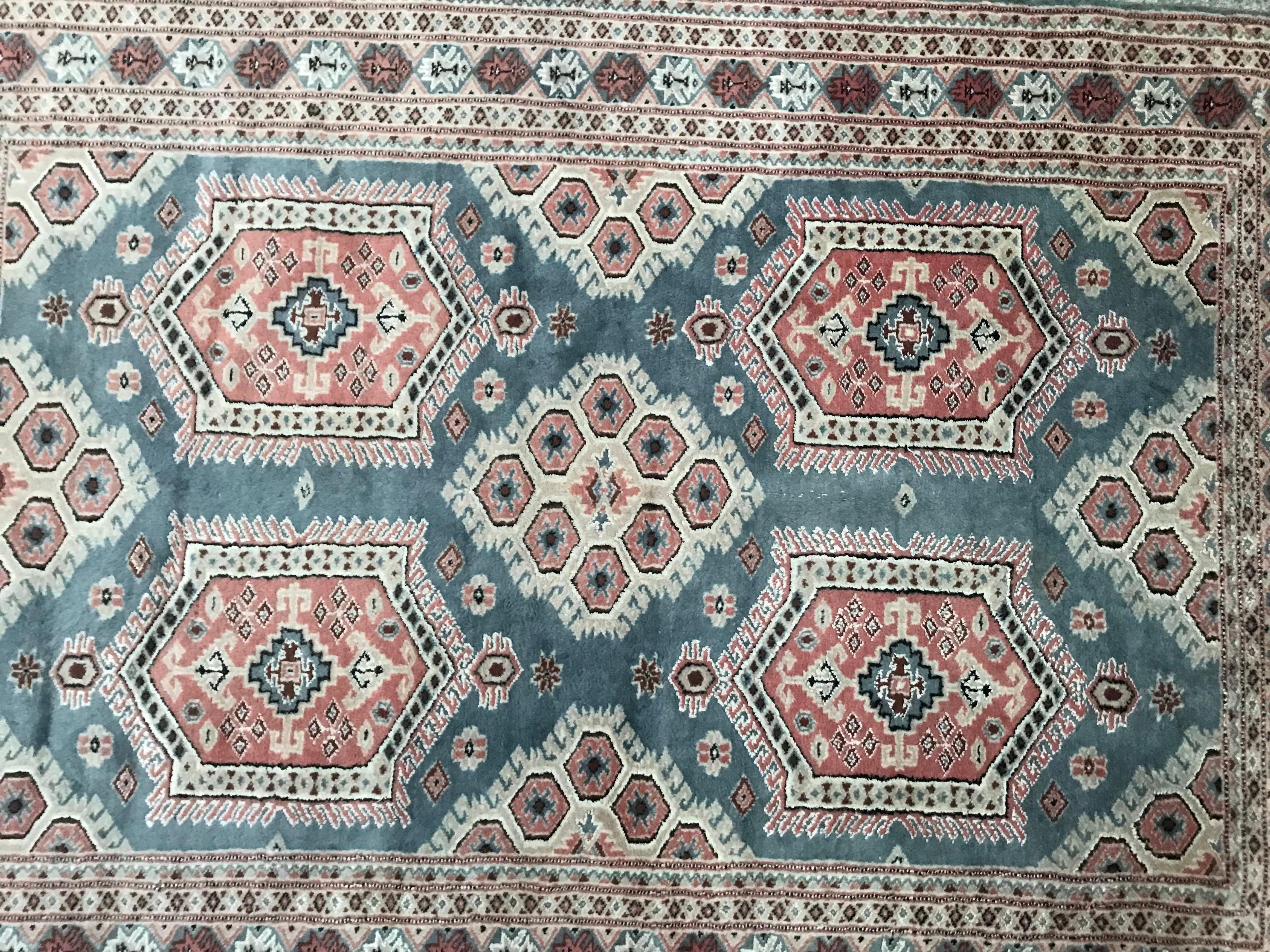 Late 20th century blue Pakistani rug with geometrical design and nice colors with blue field, orange, blue and beige, entirely hand knotted with wool and silk velvet on cotton foundations.