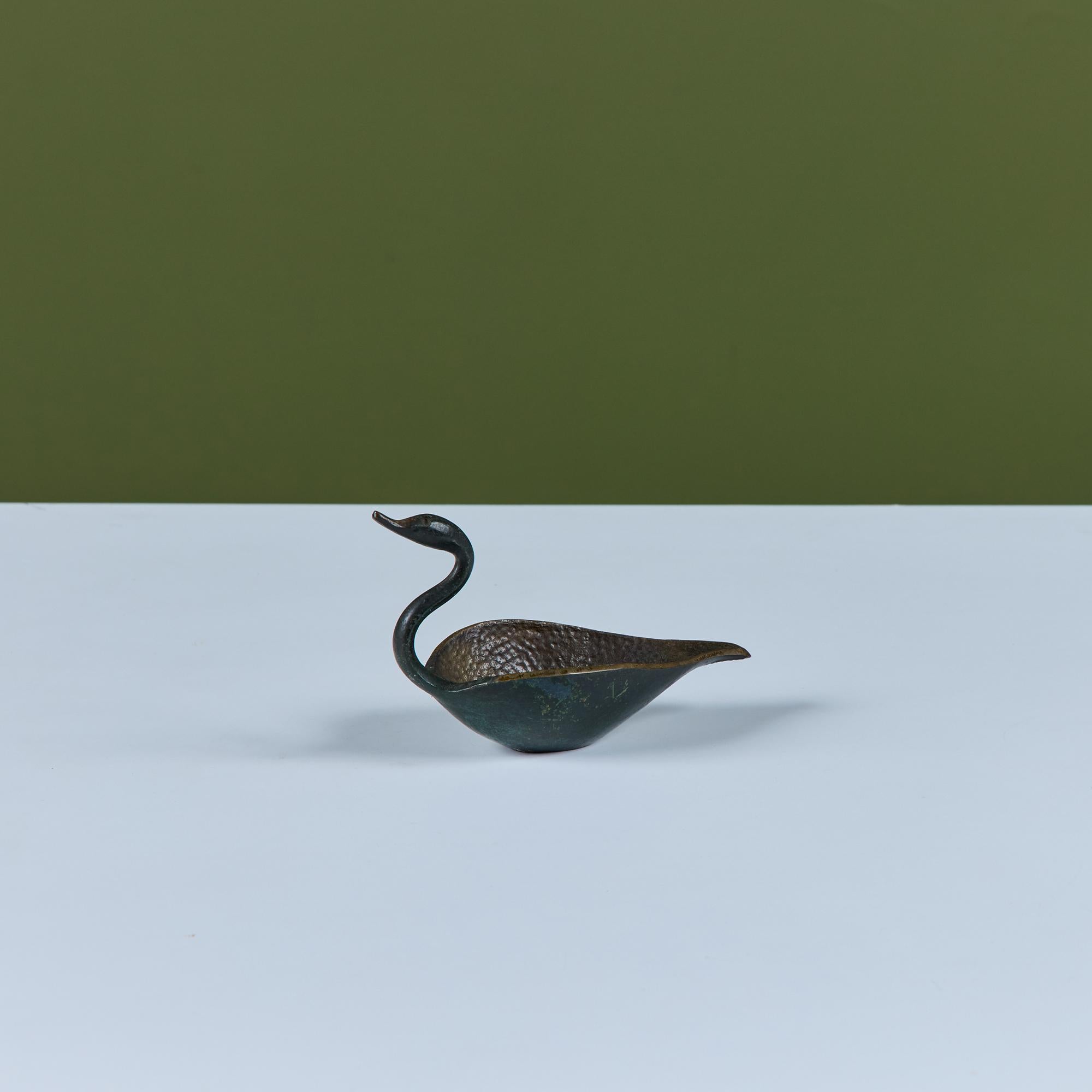 Bronze bowl in the shape of a swan by Pal-Bell. The piece features a curved neck and hammered interior with a deep well for trinkets.

Dimensions
6.75