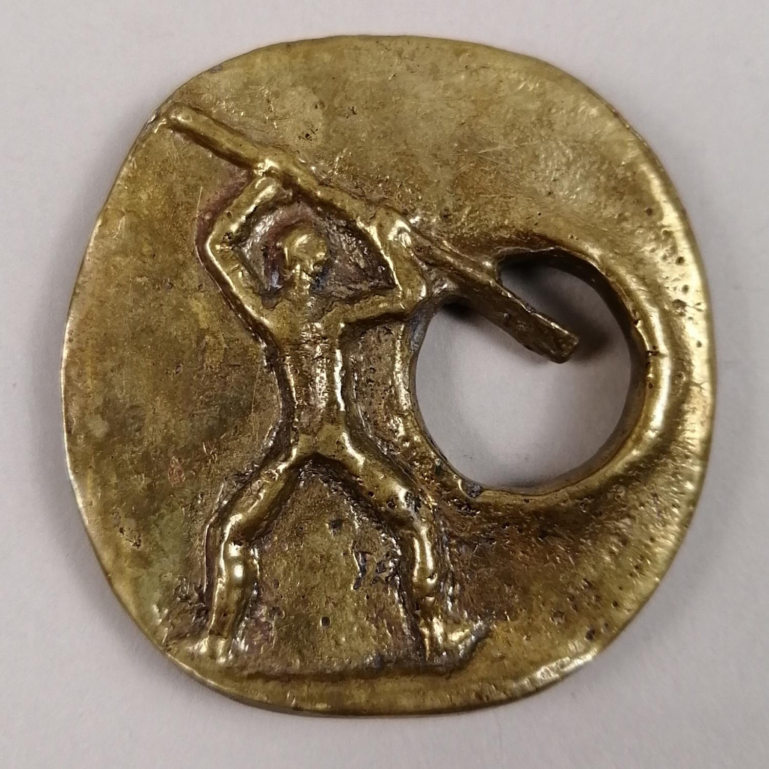 A sculptural Brutalist cast bronce buckle by Hungarian-born Mexican sculptor Pal Kepenyes. The round design features a man holding a spear, which end serves as the prong. Signed on the back.

An Hungarian-born Mexican artist, Pal Kepenyes (1926 -