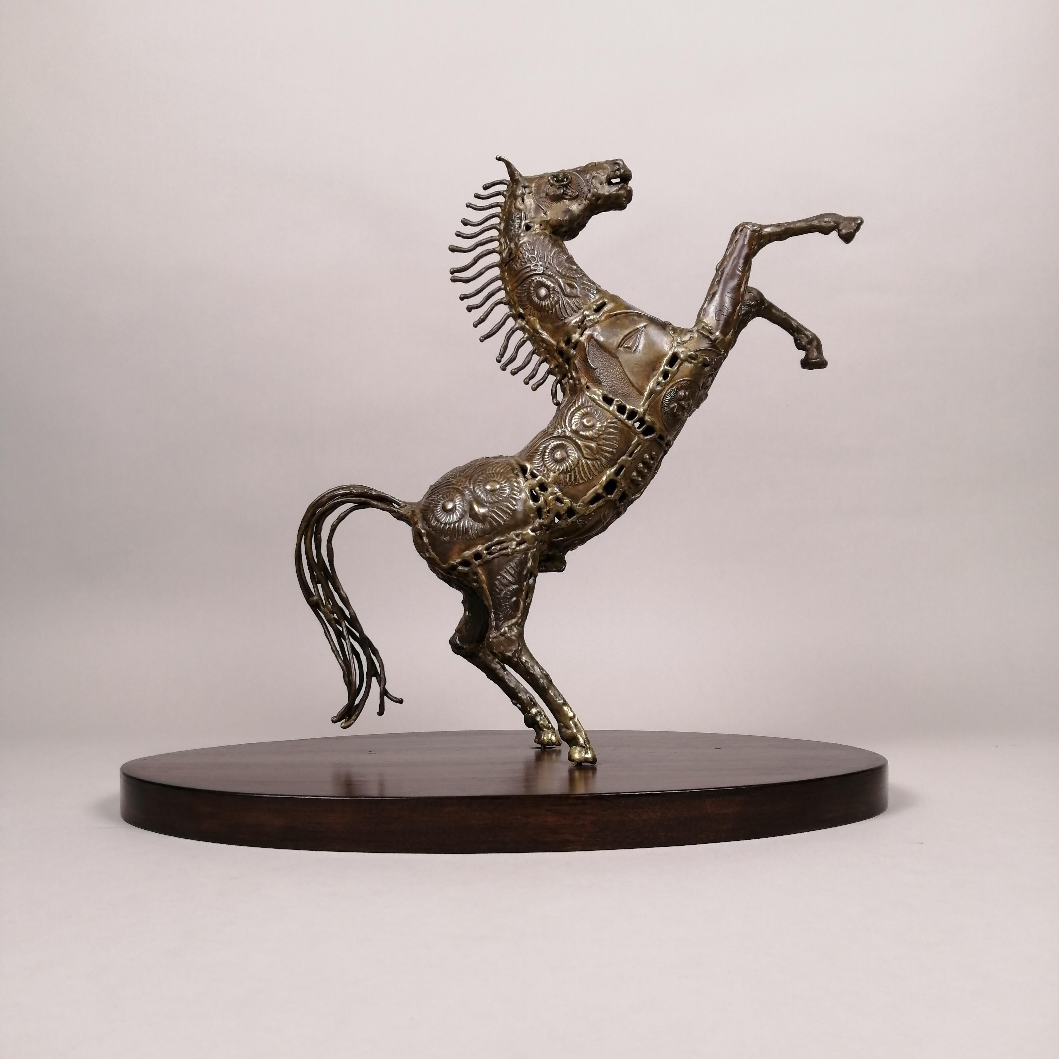 A ca. 1980 Mexican Brutalist bronze rampant horse sculpture by Hungarian-born sculptor Pal Kepenyes. The horse's body show reliefs with lions and owl's heads. The sculpture is mounted over a walnut oval base. Signed on front right leg. 

Sculpture's