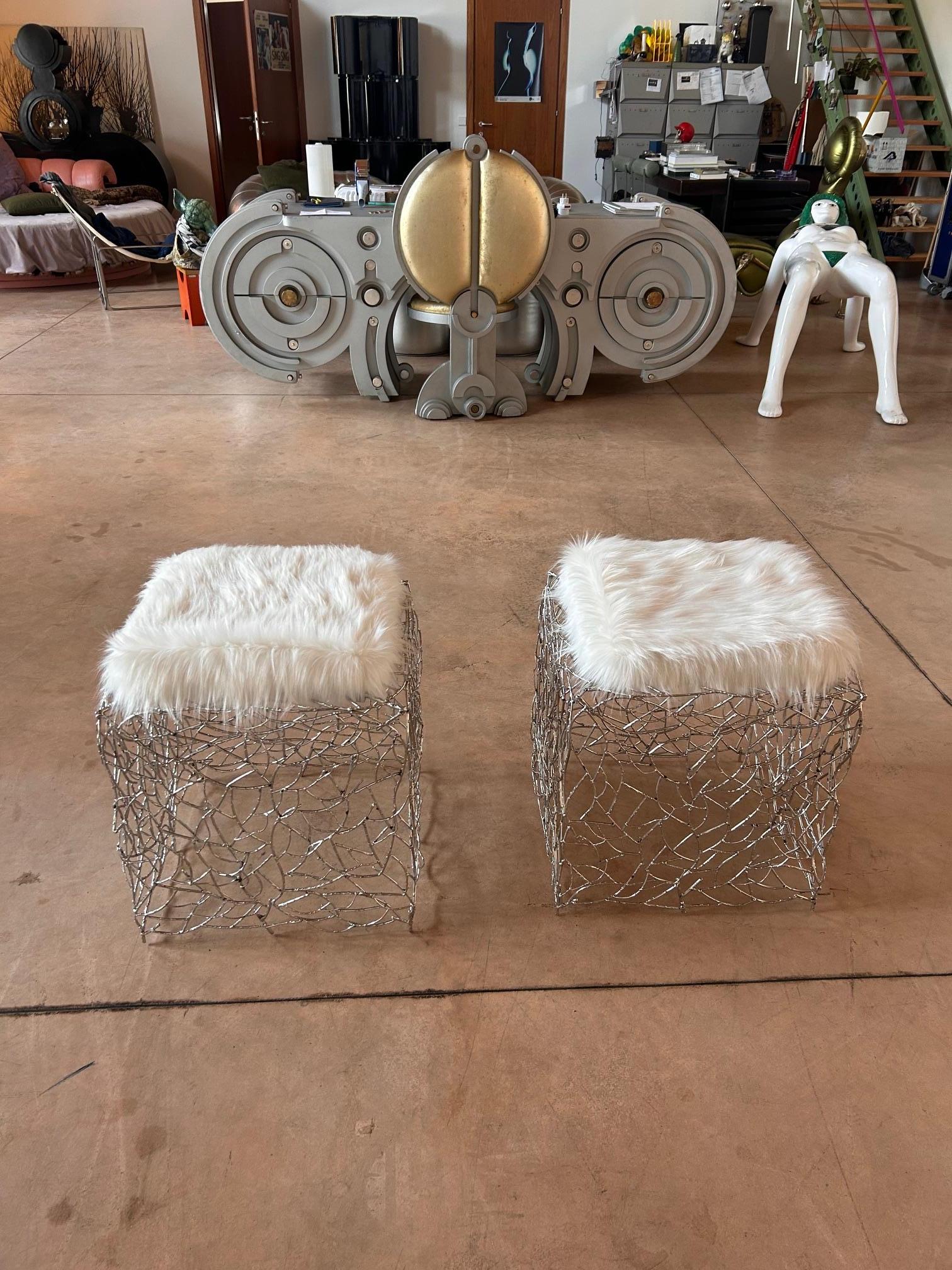 A pair of ottomans designed by the creative studio Pal Zileri for the Pitti Uomo fashion show stand in Florence Italy in 2005. Metal worked in the shape of woven twigs. Cushions covered in synthetic white fox fur.
Like-new conditions.

