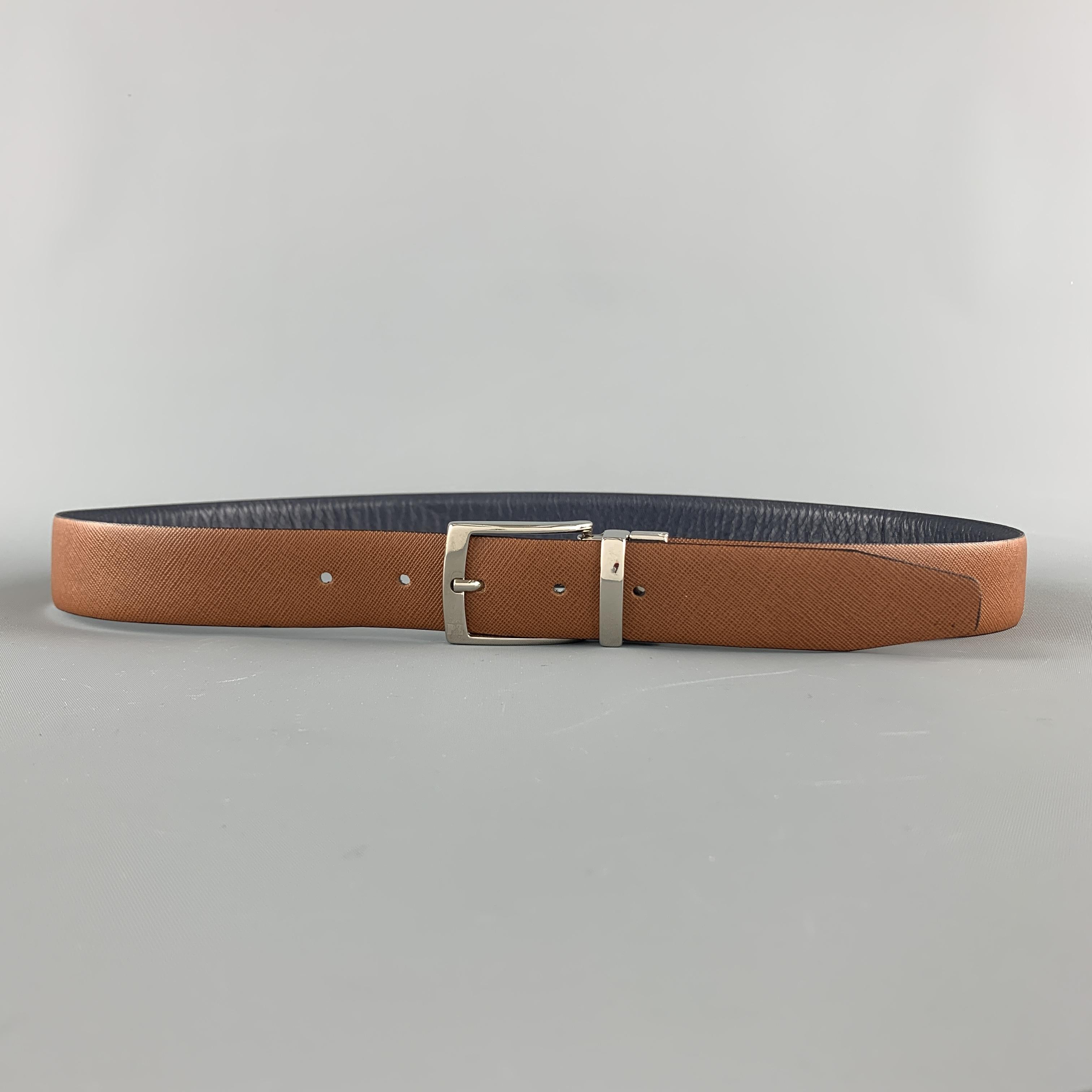 Reversible PAL ZILERI dress belt features a smooth navy blue and tan saffiano leather strap with a silver tone buckle. Made in Italy.

Excellent Pre-Owned Condition.
Marked: (no size)

Length: 43.5 in.
Width: 1.25 in.
Fits: 35-39 in.