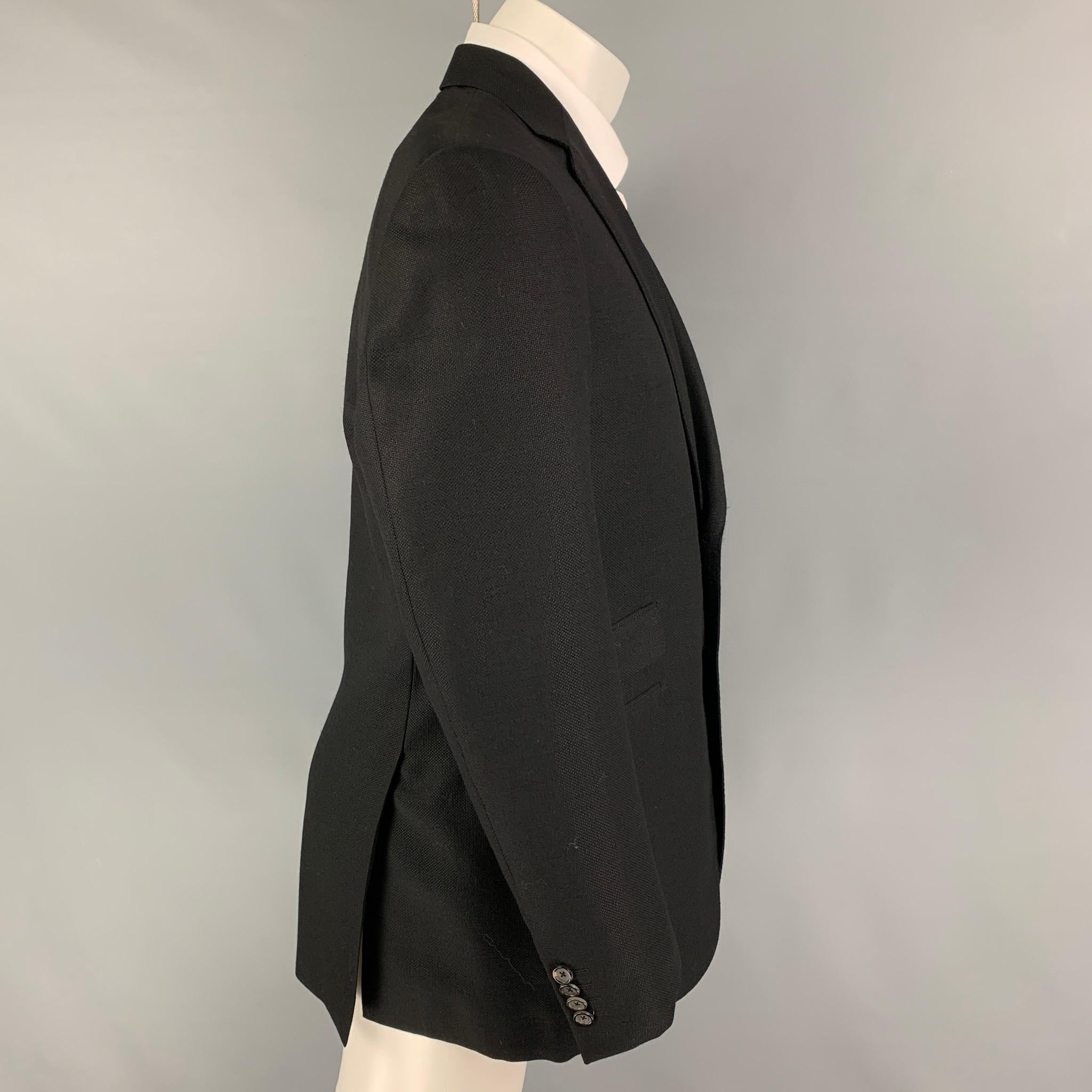 PAL ZILERI sport coat comes in a black textured wool with a full liner featuring a notch lapel, flap pockets, double back vent, and a double button closure. Made in Italy. 

Very Good Pre-Owned Condition.
Marked: 50

Measurements:

Shoulder: 18