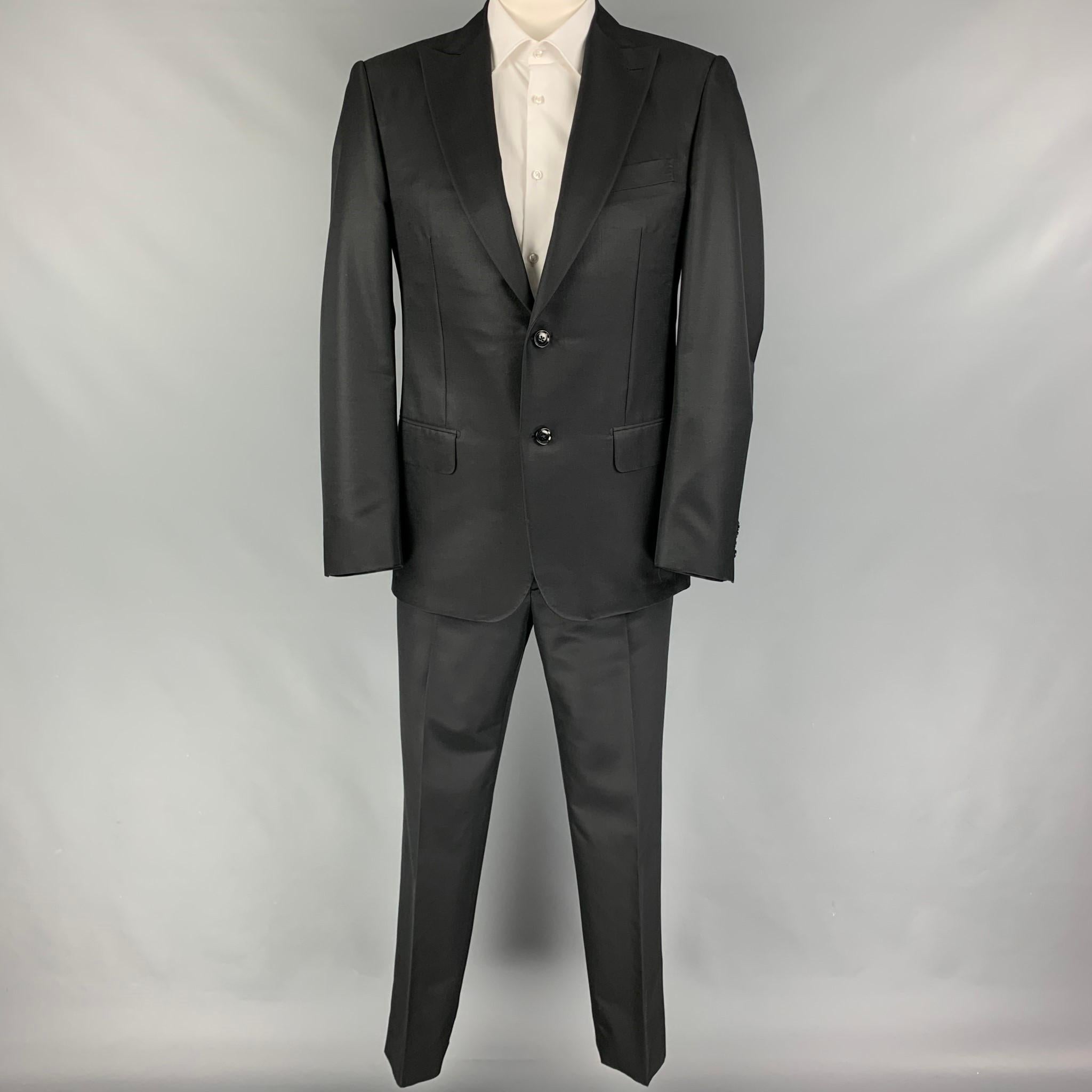 PAL ZILERI suit comes in a black wool / silk with a full liner and includes a single breasted, single button sport coat with peak lapel and matching flat front trousers. Made in Italy.

Very Good Pre-Owned Condition.
Marked: