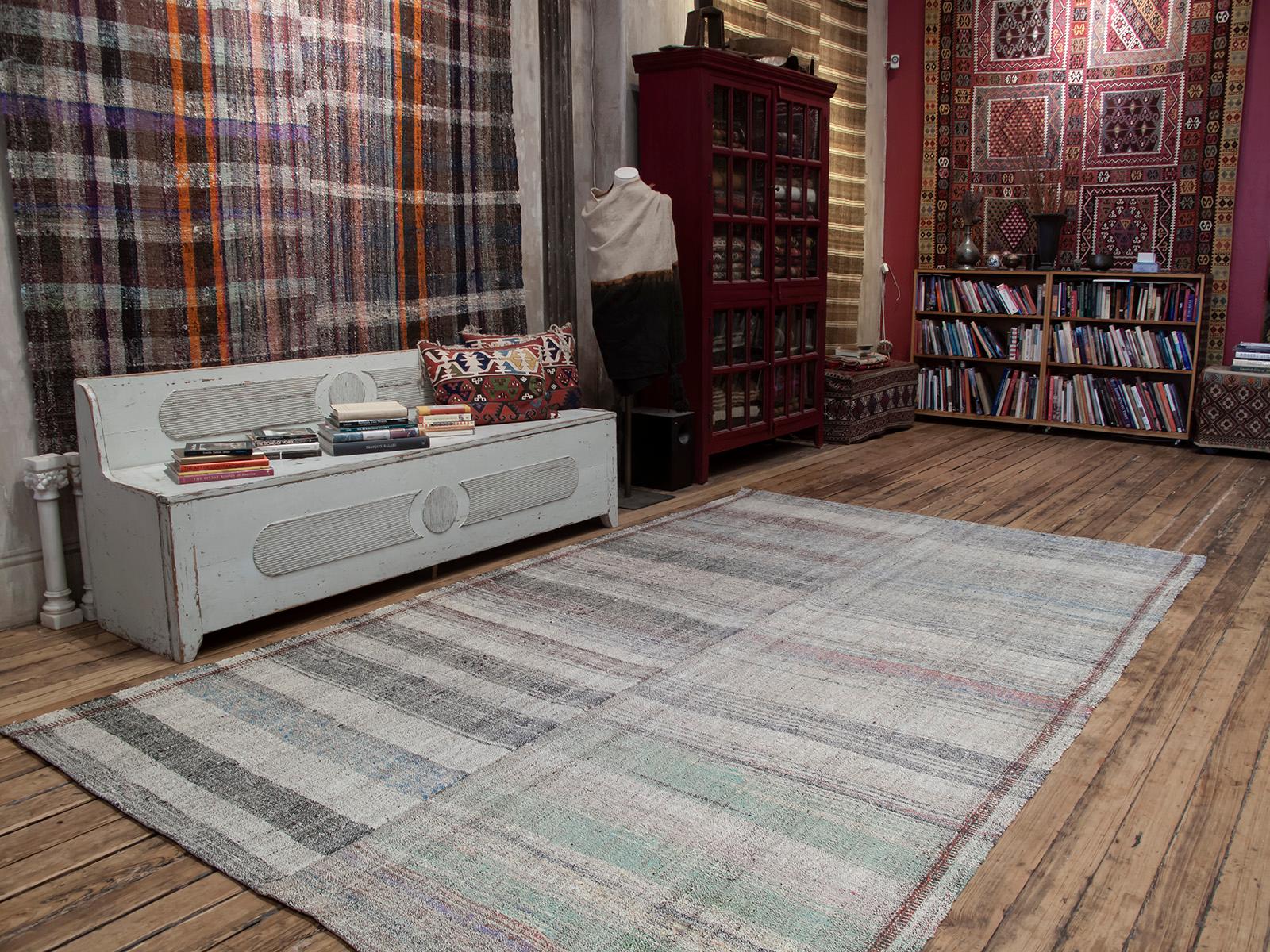 An old flat-weave from Central Turkey, woven with an ingenious mixture of colorful cotton rag and goat hair, used as a sturdy, everyday floor cover in the weaver's household. It consists of two panels woven on a narrow loom and seamed together in