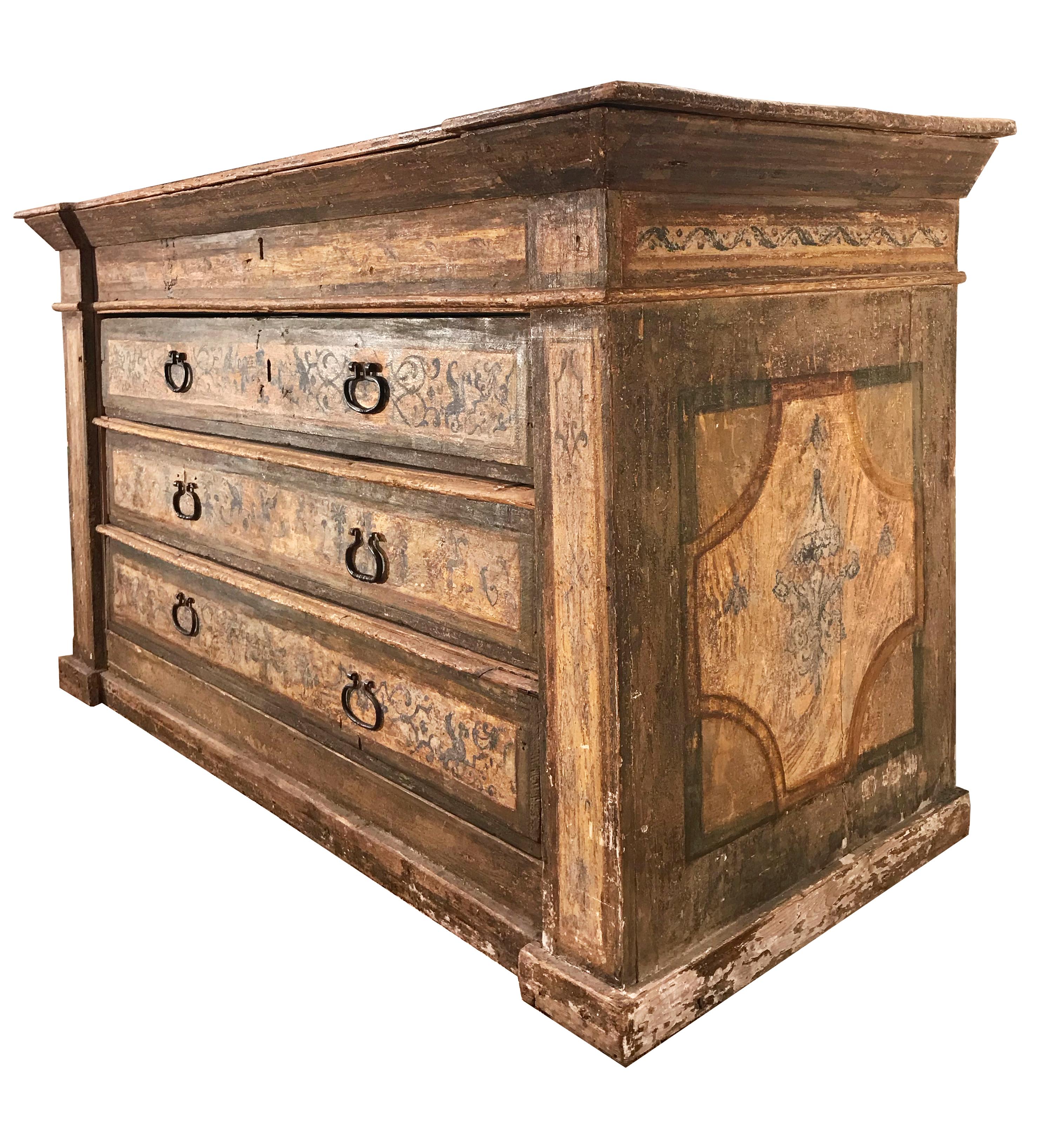 Italian Renaissance period Cassettone, or large chest of drawers, with 3-drawer and a concealed, hinged lid top, retaining its period polychrome painted arabesque decoration over pine construction with 6 iron pulls and 2 keys.
Northern Italy, 16th