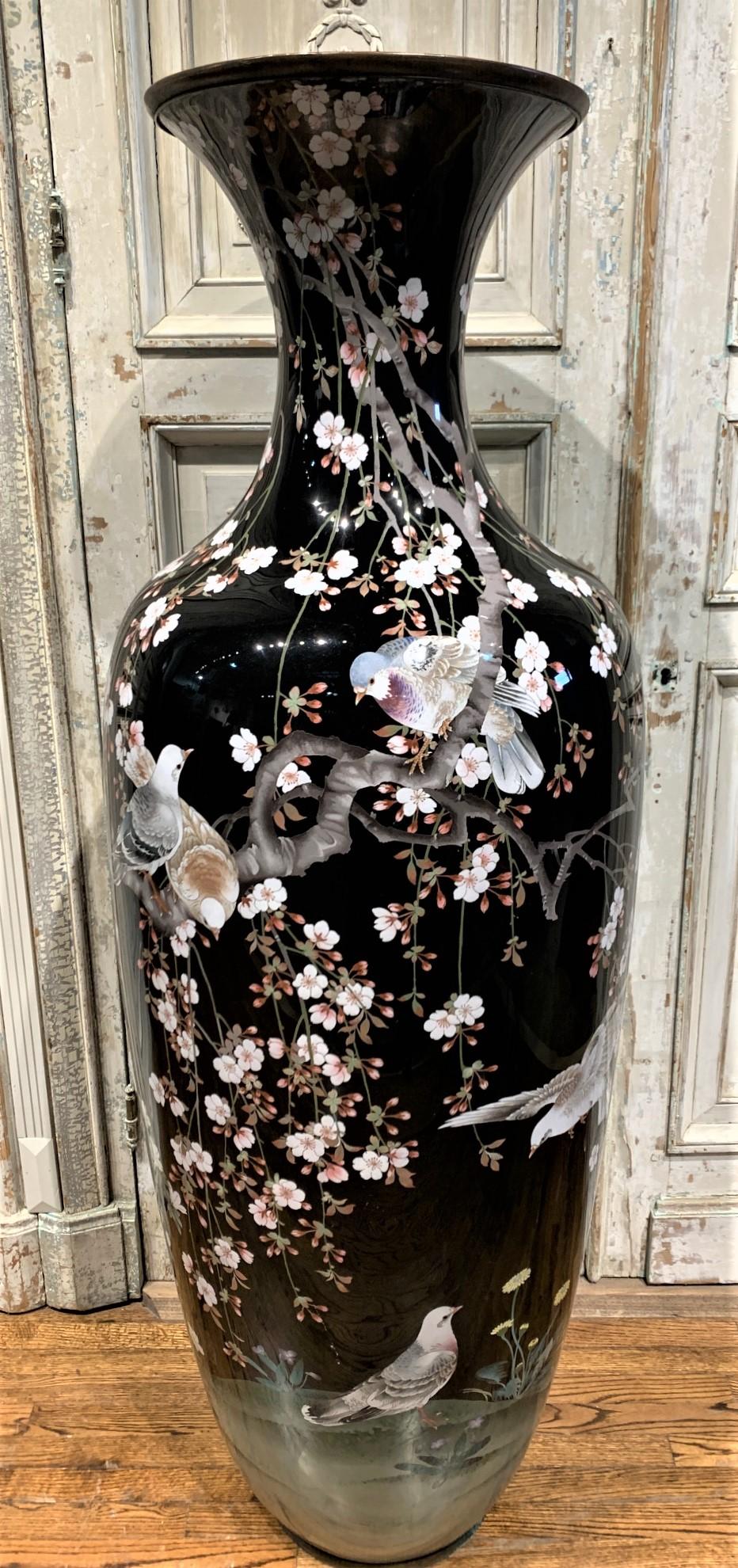 Impressive palace size 19th century Japanese cloisonné enamel narrow-neck vase. Finely decorated overall with flowering trees and colorful exotic birds on an ebony field. Rare and sought-after large scale,

circa 1890.