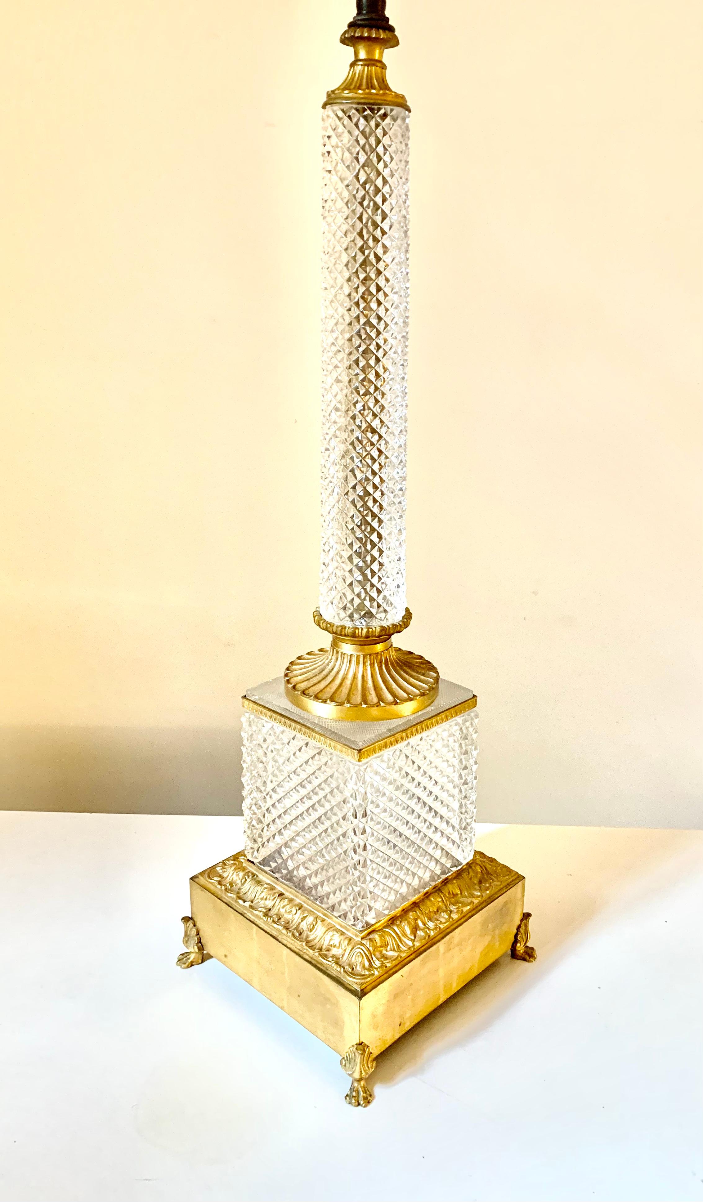 Impressive, oversize, Baccarat quality diamond cut crystal and gilt bronze Neoclassical style table lamp.
19th Century
France
Circular diamond cut crystal column with finely fluted gilt bronze capitol and base on an exquisite, minutely detailed