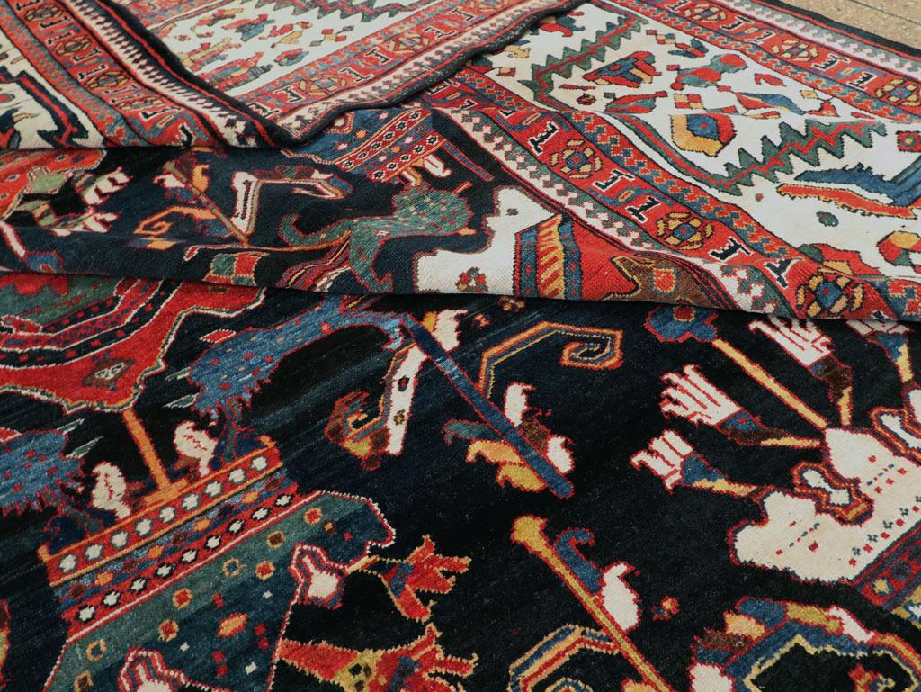 A magnificent palace size early 20th century Persian Bakhtiari rug from the early 20th century. Large scale all-over design on a dark brown and navy blue ground with lobed diamond shaped medallions with attached top and bottom royal crowns flanked