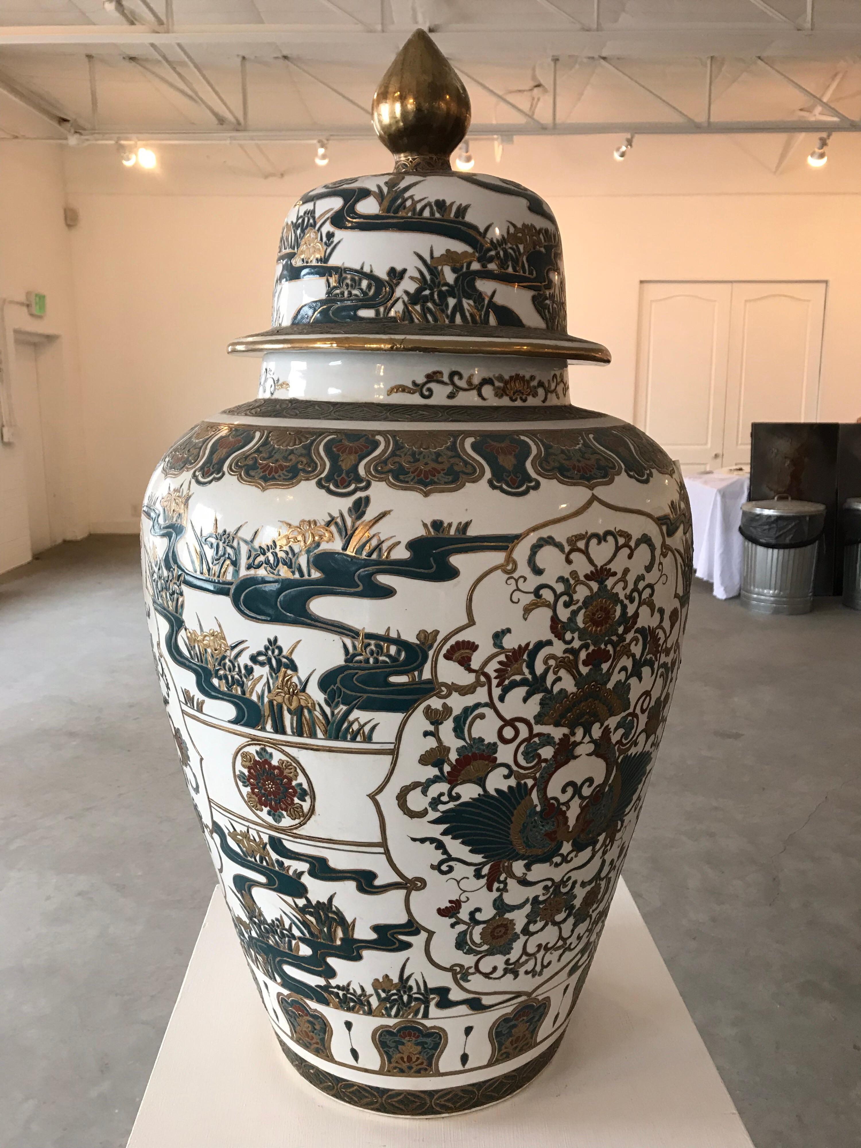 This large jar is over 30 inches tall Satsuma style decoration. There are red, gold and green tones among others, 1930s-1940s.