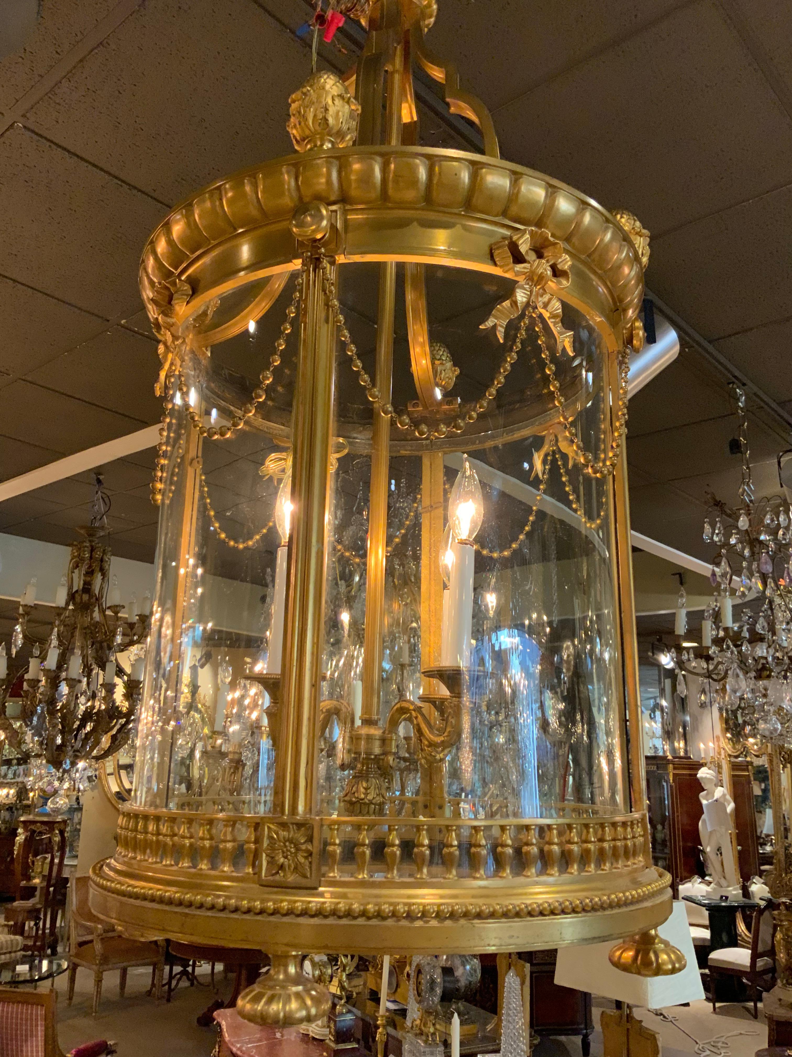 Large and exquisite lantern having 4 large cast acorn finials at the crest.
Four lights inside the glass surround. bows with connecting swags decorate 
The circumference.