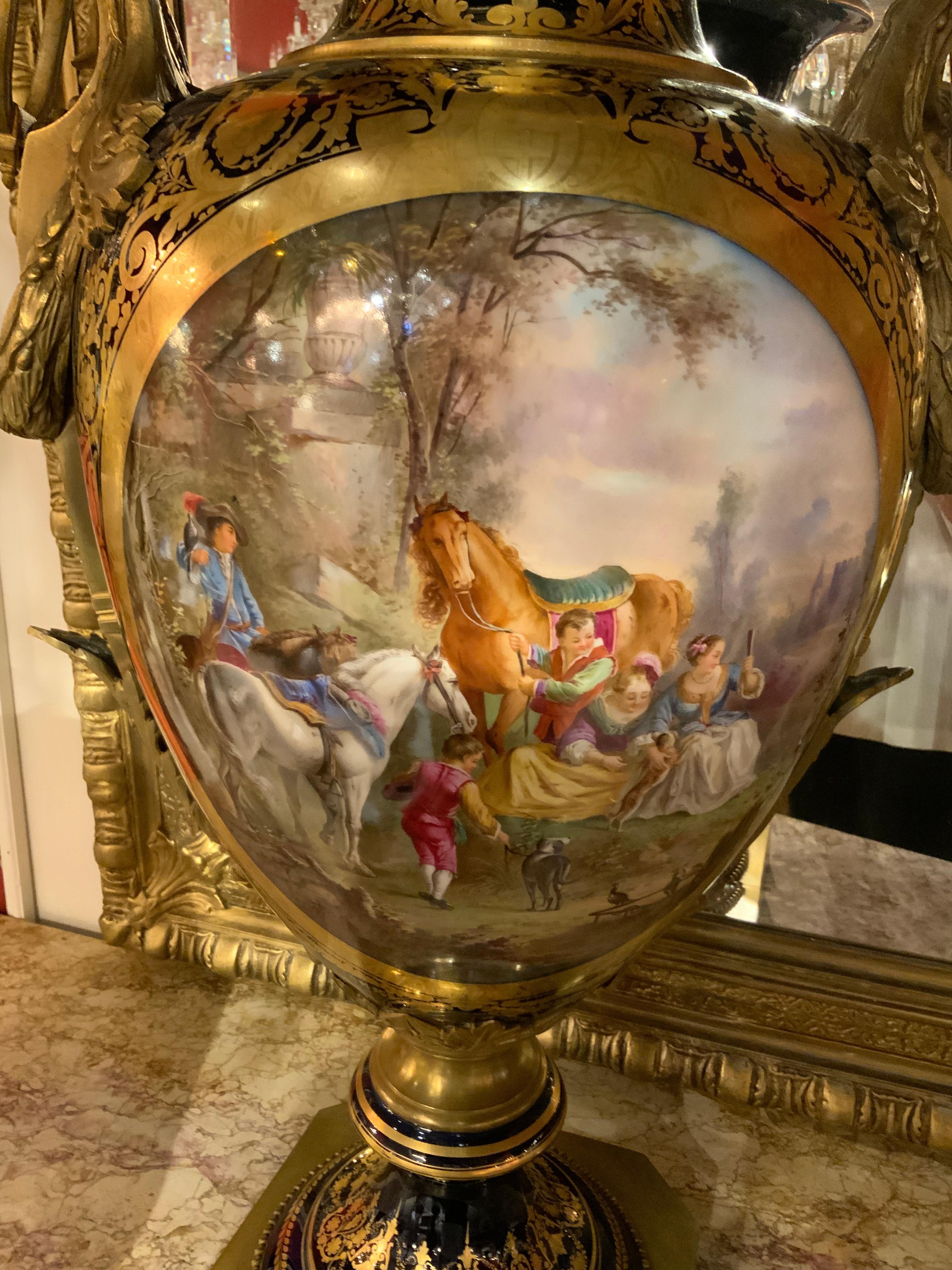 This palace size vase is made of very fine Sevres porcelain 
And has cameos in an oval shape that depict a classical
Scene on one side and a landscape on the verso. The ground
Hue is a deep cobalt hue and the mounts are well cast ornate
Bronze
