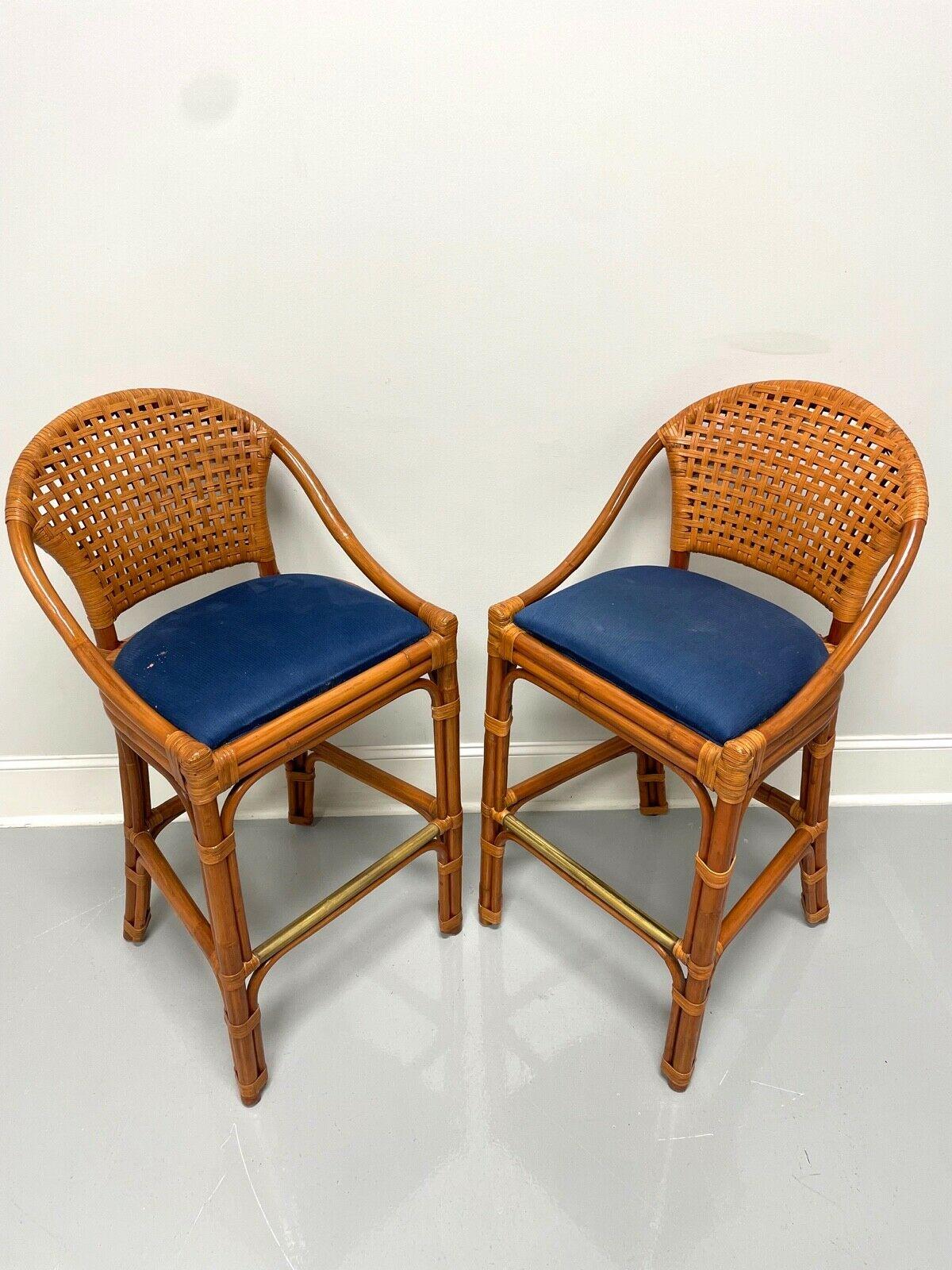 A pair of bar height barstools in a Contemporary style by Palacek. Faux bamboo, woven rattan backs & wrapping, blue corduroy fabric upholstered seats and tubular copper footrest. Made in the Philippines, in the early 21st Century. 

Measures: