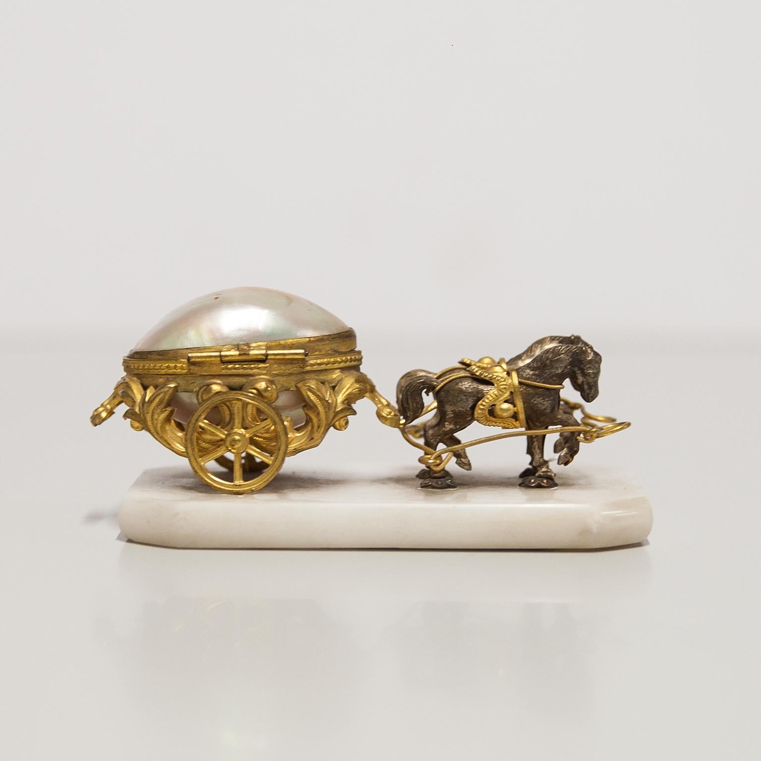 A ‘Palais Royal’ miniature horse-drawn carriage trinket box made with mother of pearl, silver-plated horses and gold plated metal. 19th century.
