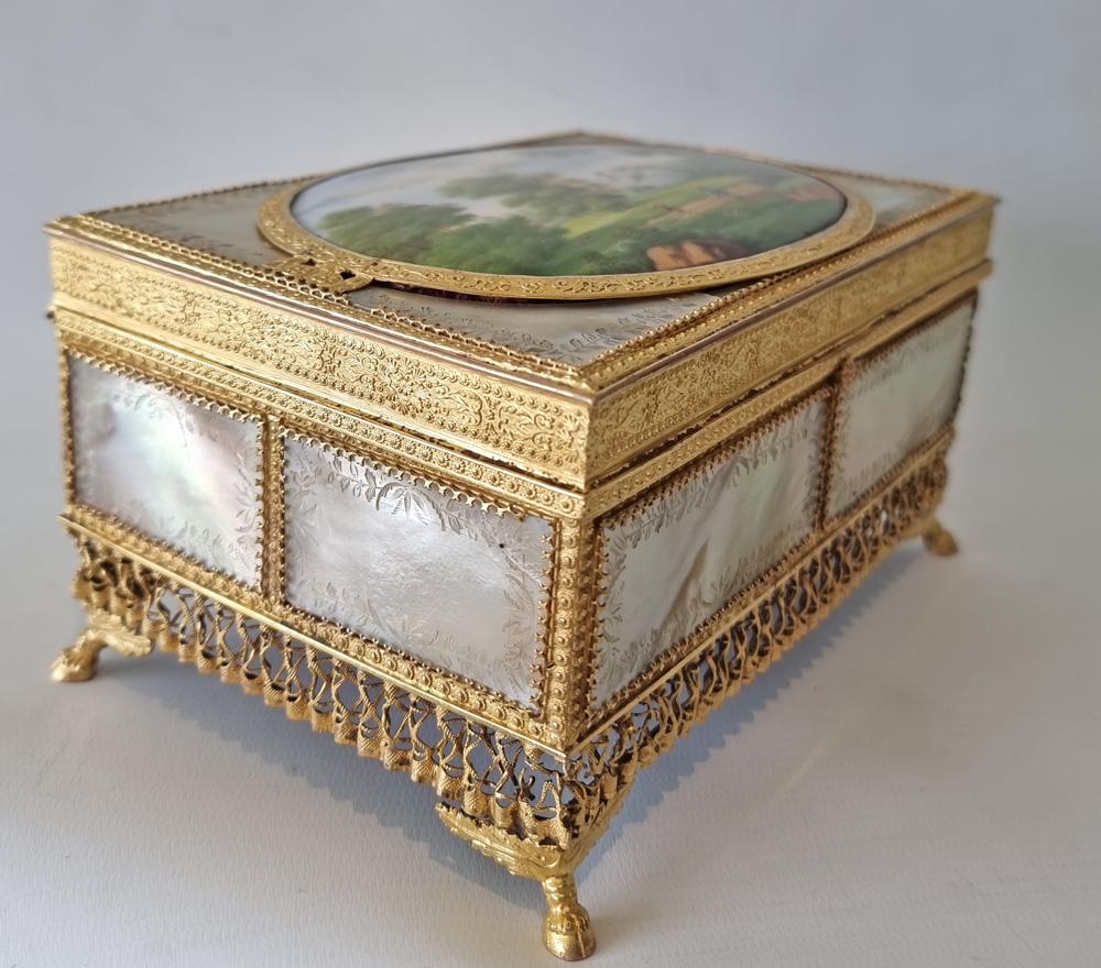 A superb early 19th Century Palais Royal, engraved mother of Pearl, Ormolu and painted porcelain Jewellery Box. Wonderful quality on this piece, the hand painted porcelain panel depicting a hunting scene. Signed on the back of the porcelain. The