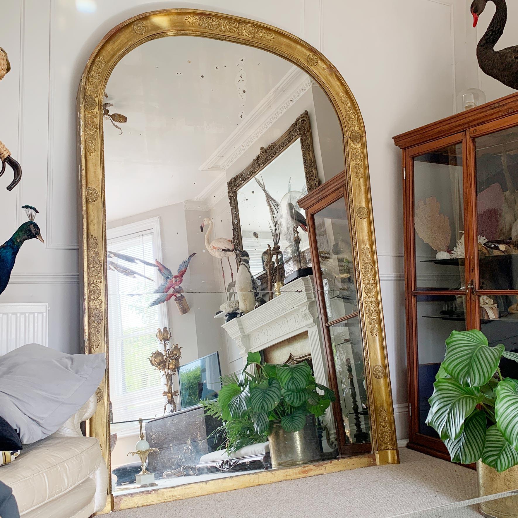 A magnificent over-mantle 19th century French mirror in the Louis Philippe style, the incredible split plate with superb foxing sits within the splendid wooden frame with gilt gesso decoration.

The size and proportions of this mirror cannot be